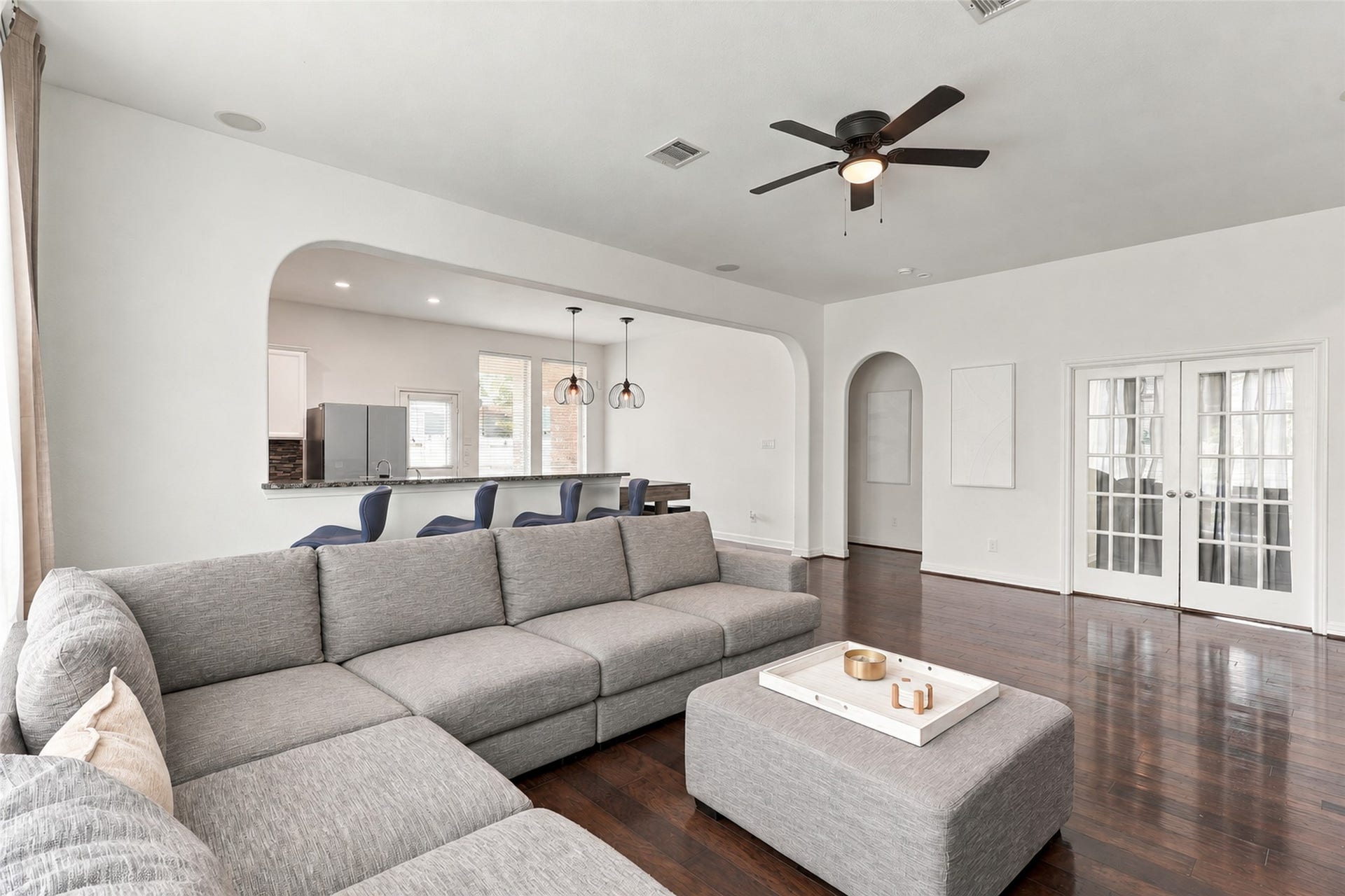 326 Lake Rim Drive, Rosenberg, TX 77469 Living room with a ceiling fan, tall windows, and a wood accent wall.