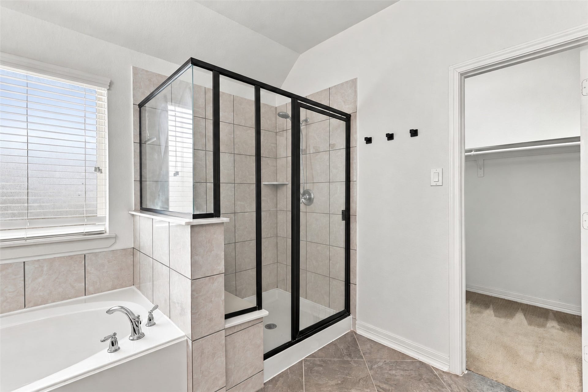 326 Lake Rim Drive, Rosenberg, TX 77469 Additional primary bathroom view featuring the glass-enclosed shower, soaking tub, and walk-in closet access.