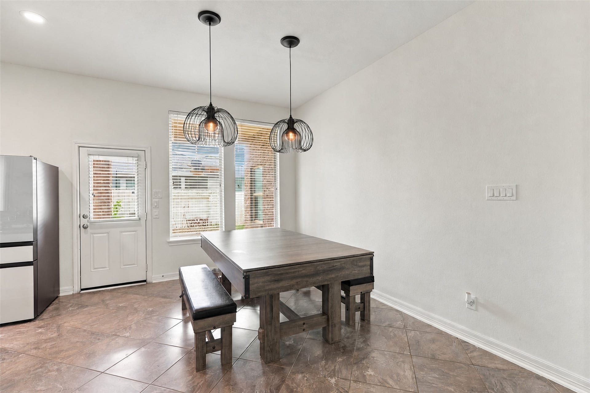 326 Lake Rim Drive, Rosenberg, TX 77469 Breakfast area with pendant lighting, large windows, and backyard access.