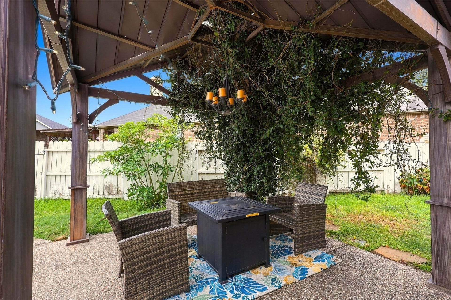 326 Lake Rim Drive, Rosenberg, TX 77469 Gazebo seating area with a fire table and string lighting.
