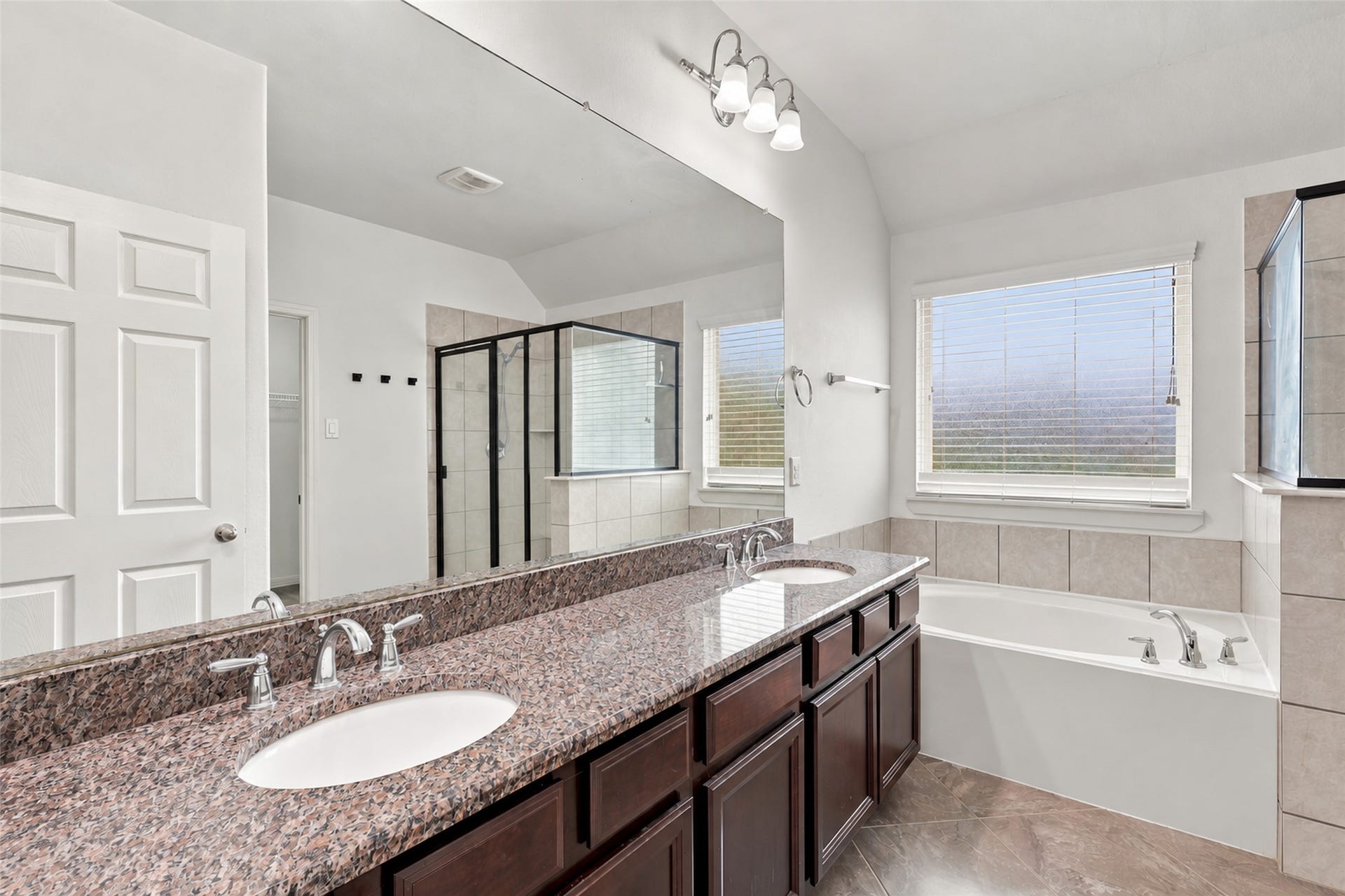 326 Lake Rim Drive, Rosenberg, TX 77469 Primary bathroom with dual sinks, granite countertops, and a separate soaking tub.