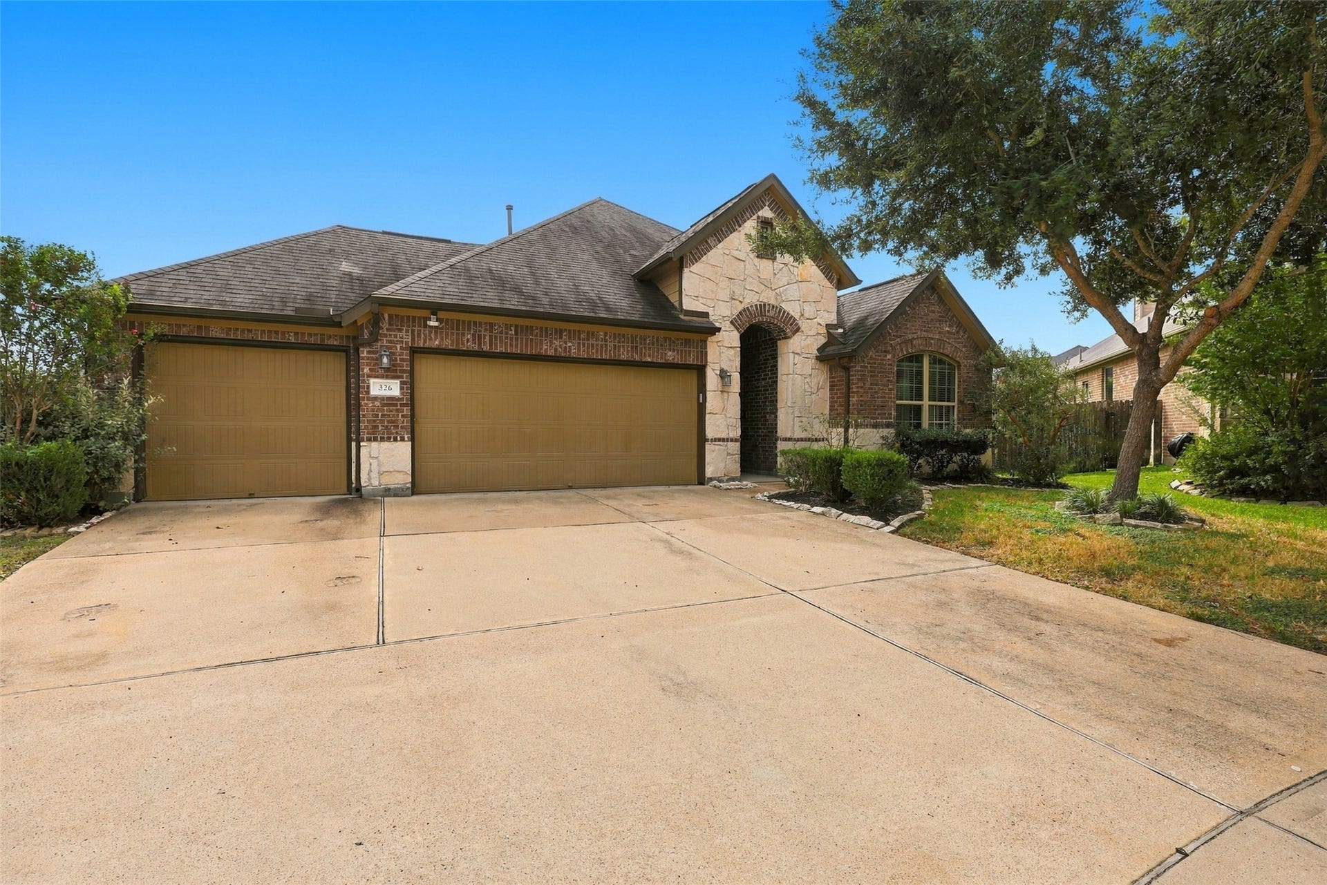326 Lake Rim Drive, Rosenberg, TX 77469 Alternate front view highlighting the three-car garage and covered entry.