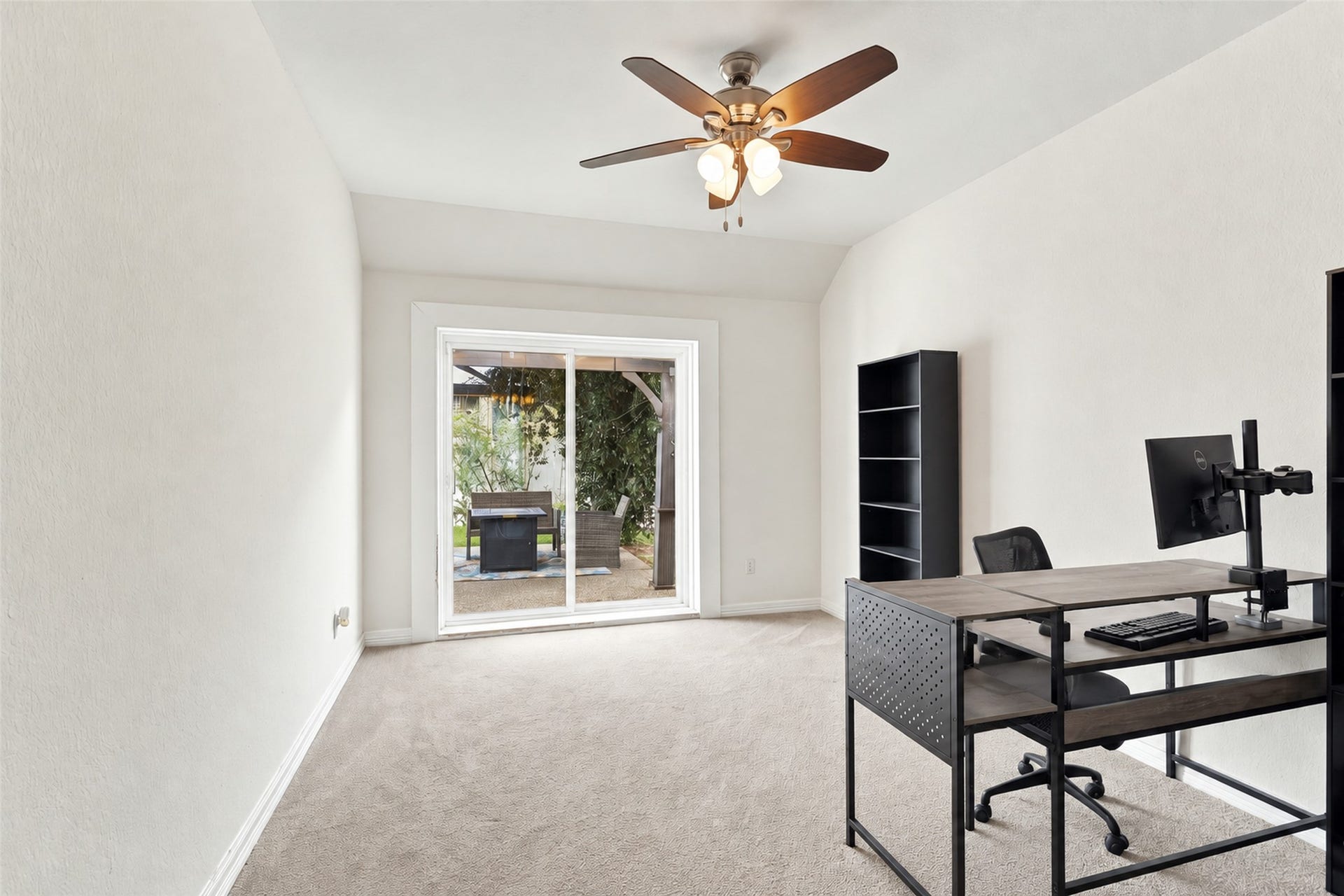 326 Lake Rim Drive, Rosenberg, TX 77469 Flexible room with a ceiling fan and sliding glass doors leading to the backyard.