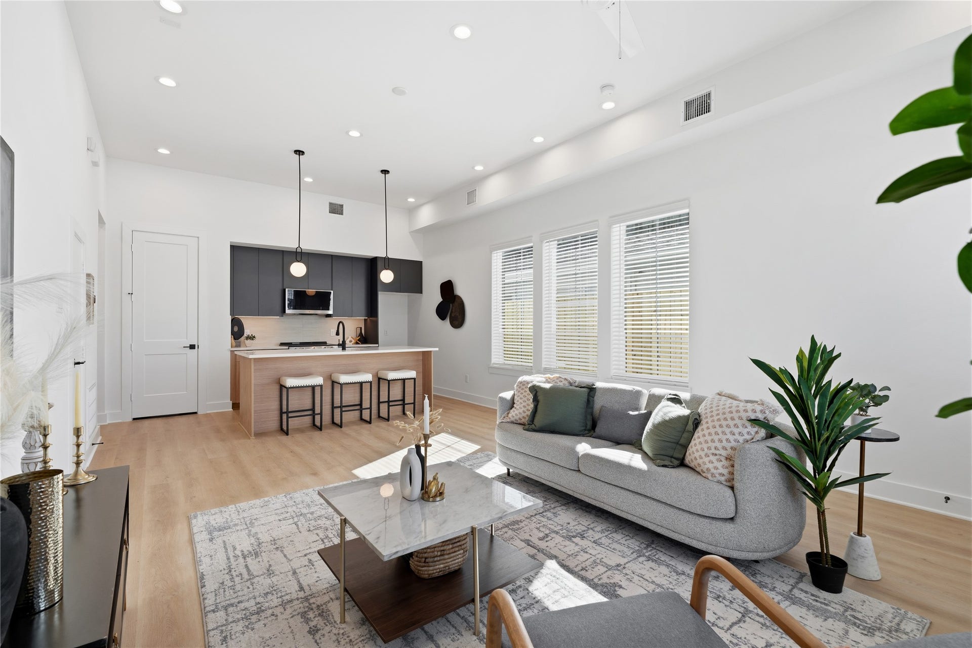 Open-concept duplex layout with seamless flow between the living area and kitchen, ideal for entertaining.