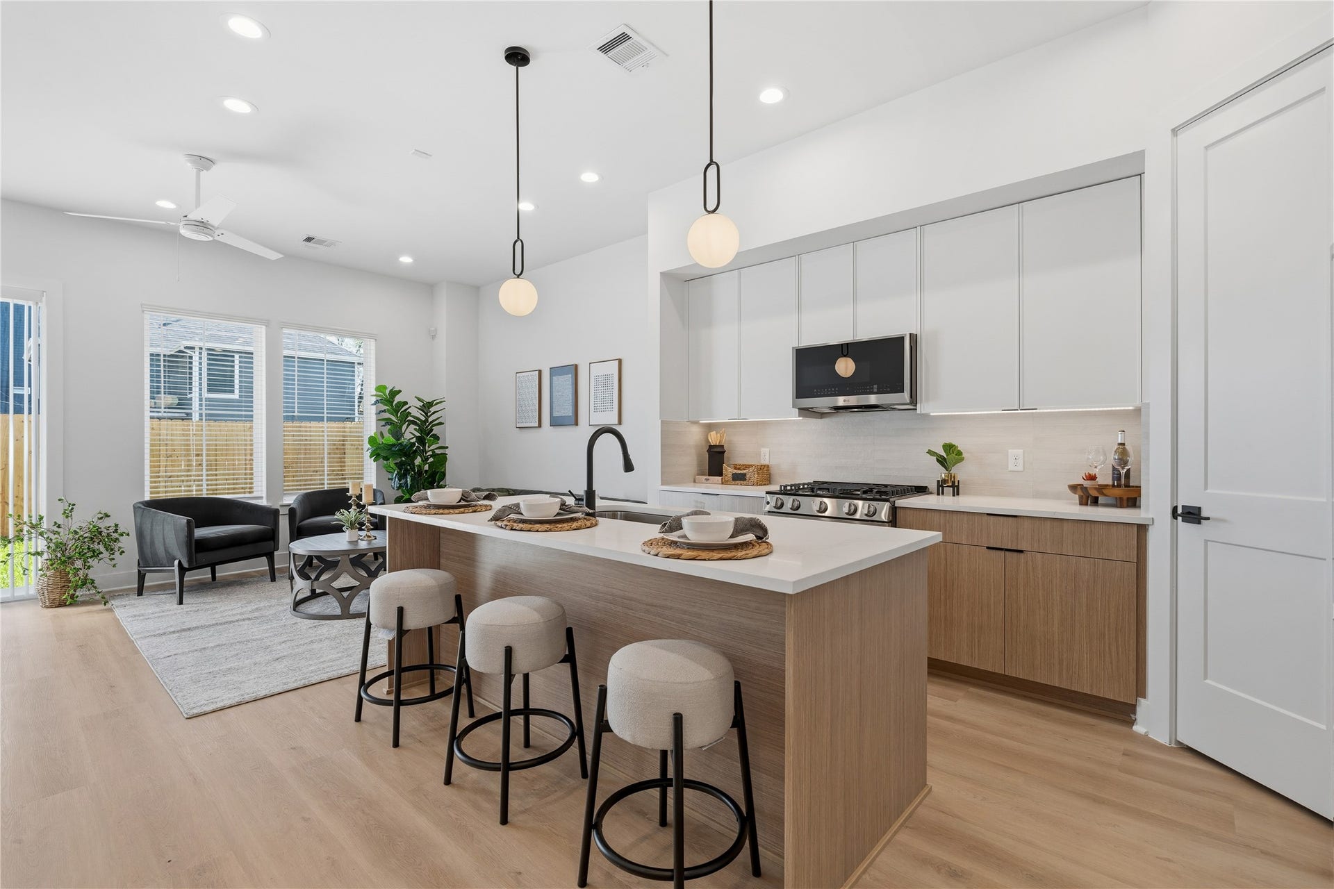 Open-concept single-family living space with 10 ceilings, defined seating area, and easy flow into the kitchen and dining.