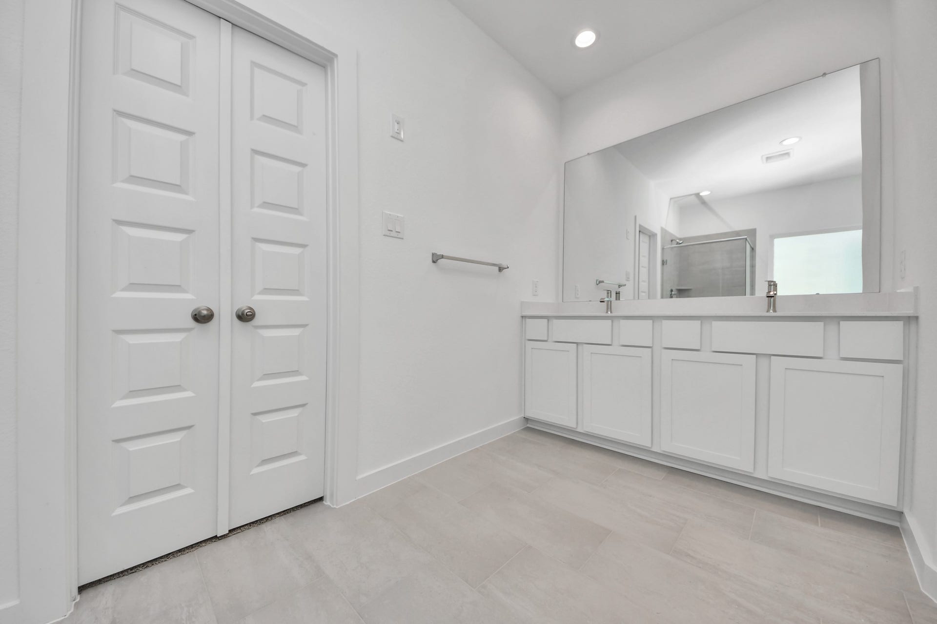 24511 Broad Park Ct, Spring, TX 77373 Elevate your daily routine at the elegant vanity, now equipped with double sinks, light countertops, modern hardware, and beautiful recessed lights. Sample photo of completed home with similar floor plan. Actual colors and selections may vary.