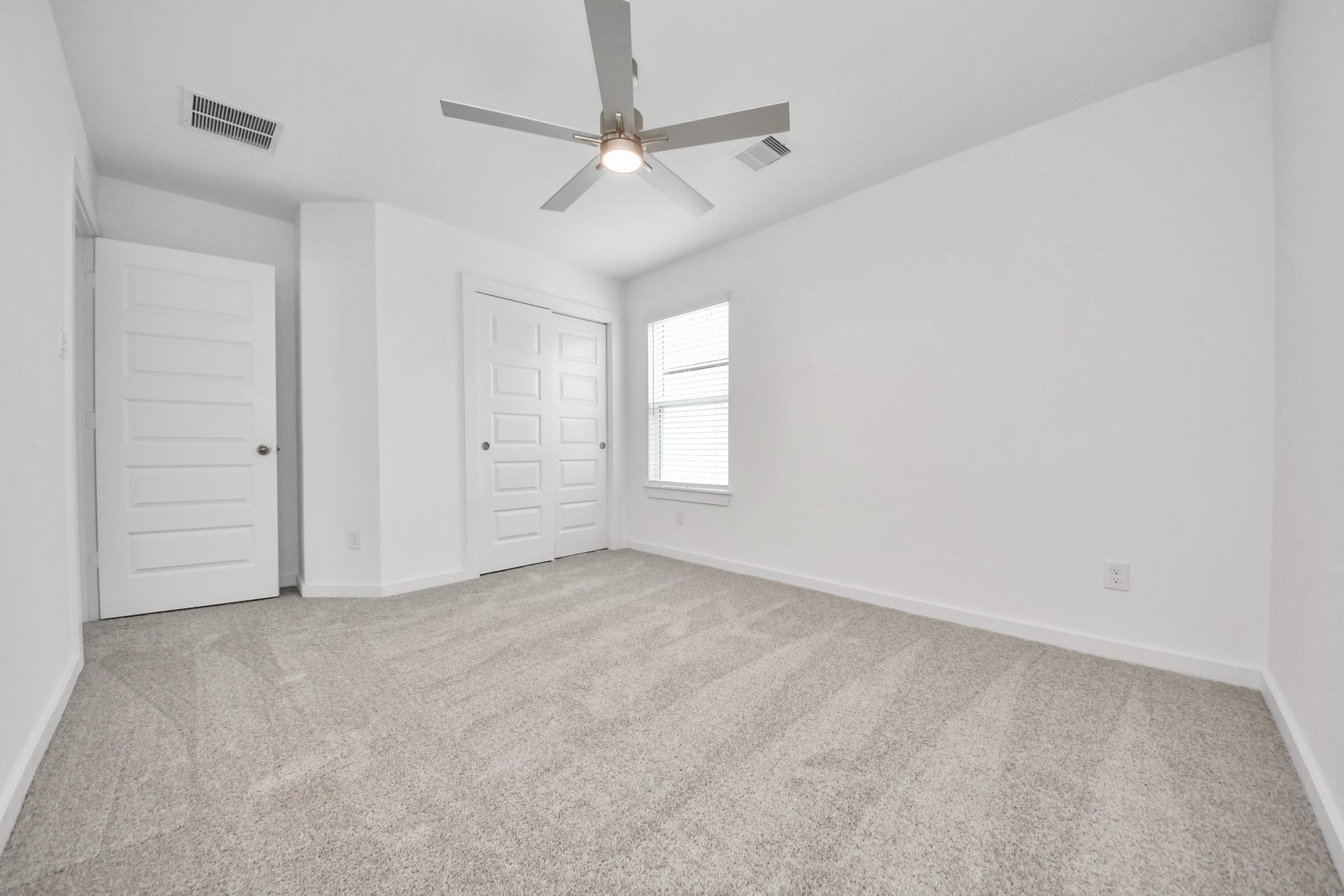 24511 Broad Park Ct, Spring, TX 77373 Secondary bedroom features plush carpeting, large windows that let in plenty of natural light, bright paint, and spacious closets. Sample photo of completed home with similar floor plan. Actual colors and selections may vary.