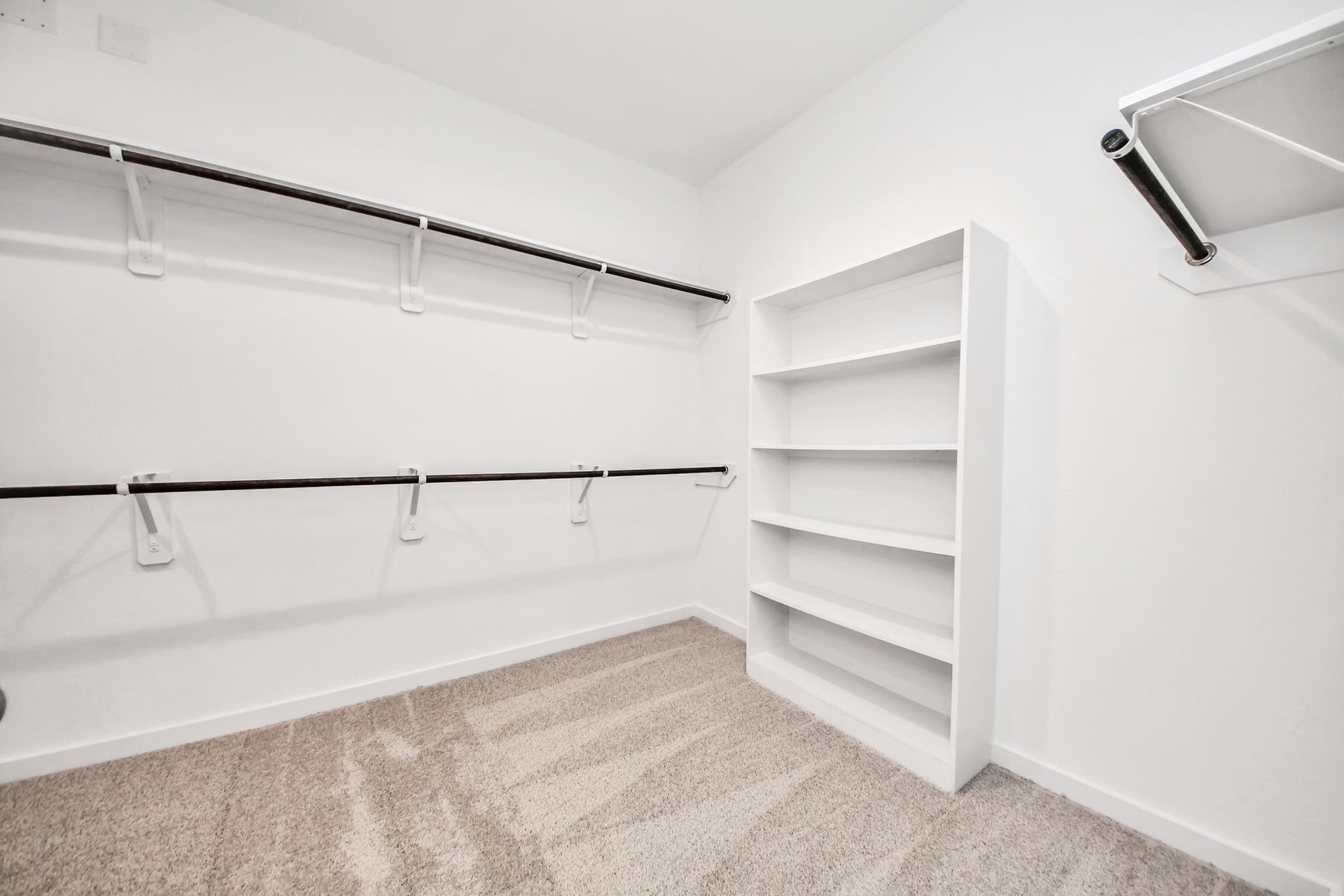24511 Broad Park Ct, Spring, TX 77373 Walk-in closet that epitomizes luxury and practicality. This generously sized space features built-in shelving, offering abundant room for impeccable organization. High ceilings and recessed lighting create a bright and welcoming ambiance. Sample photo of completed home with similar floor plan. Actual colors and selections may vary.