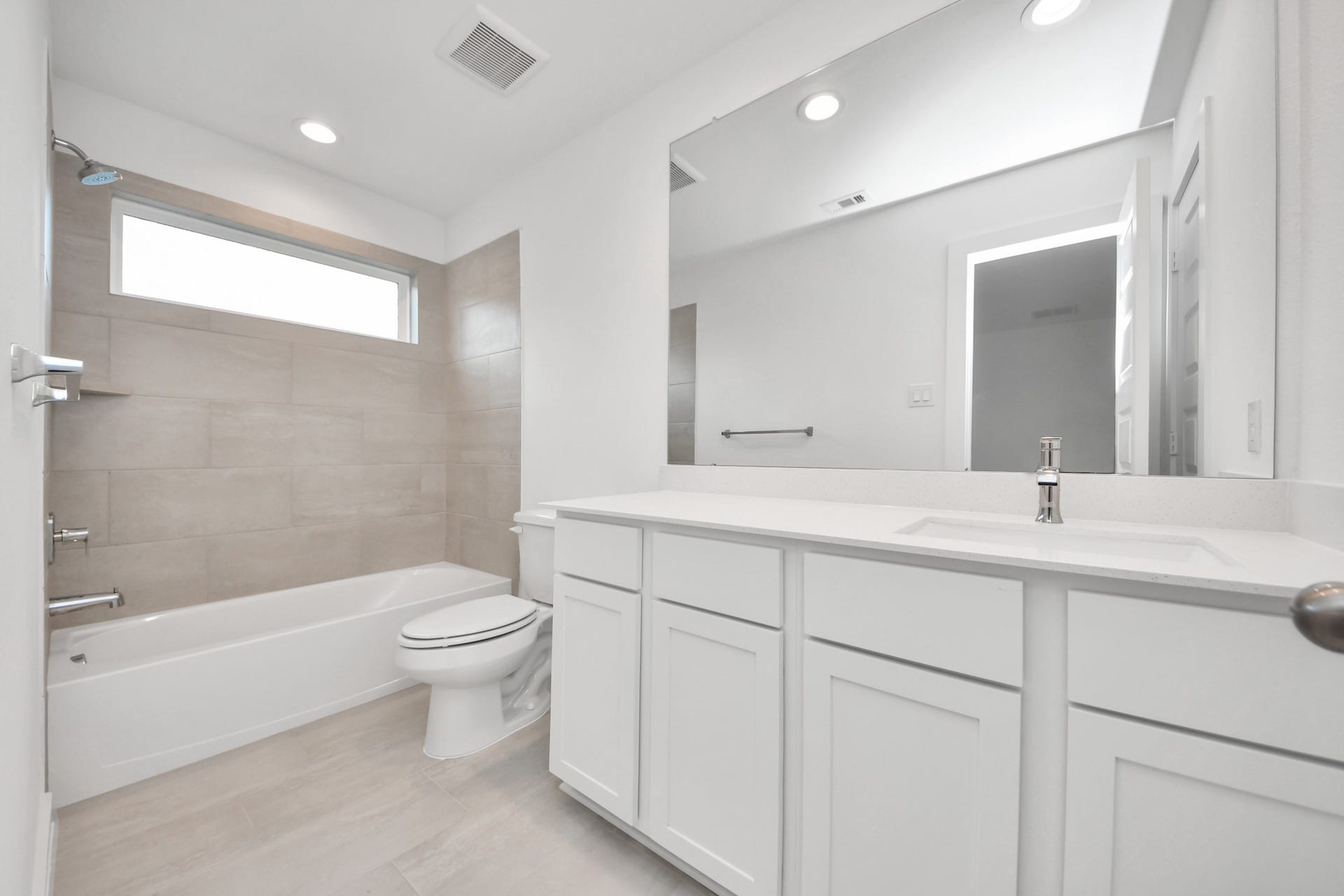 24511 Broad Park Ct, Spring, TX 77373 Secondary bath features tile flooring, bath/shower combo with tile surround, light stained wood cabinets, beautiful light countertop. Sample photo of completed home with similar floor plan. Actual colors and selections may vary.