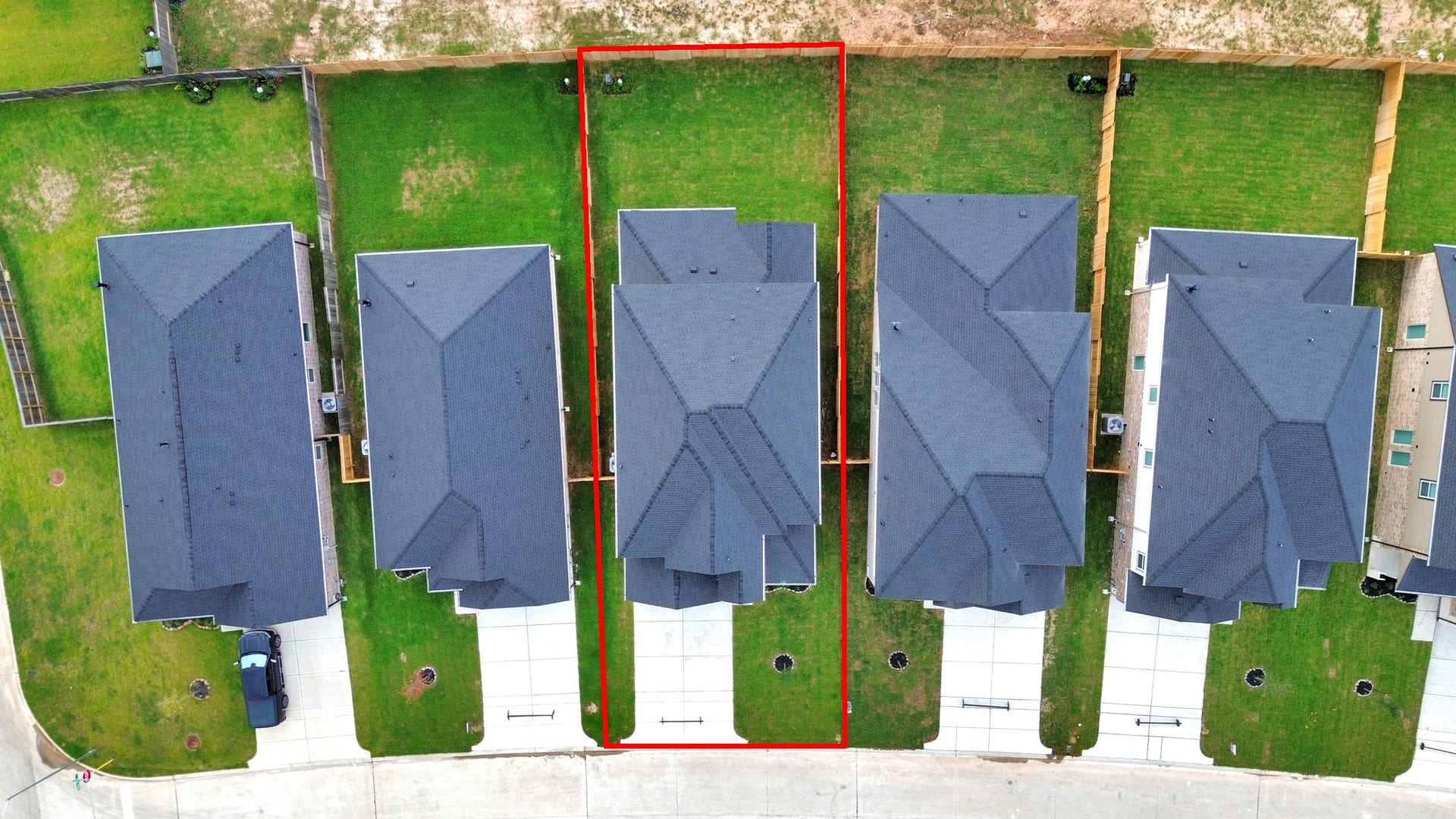 24511 Broad Park Ct, Spring, TX 77373 An aerial view of a spacious subdivision lot, highlighting a well-maintained yard and a fully fenced perimeter, offering both privacy and expansive outdoor space.