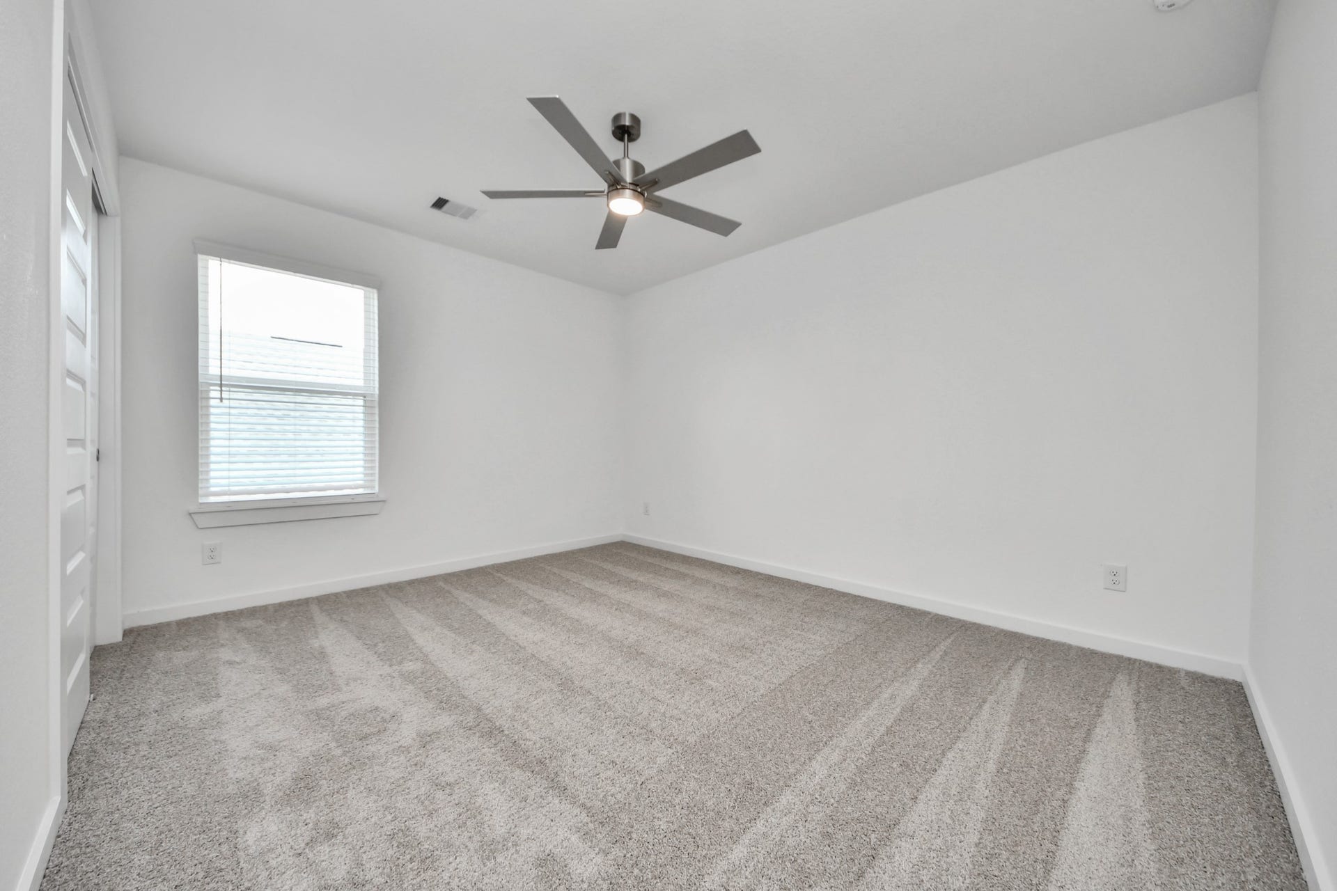 24511 Broad Park Ct, Spring, TX 77373 Secondary bedroom features plush carpeting, large windows that let in plenty of natural light, bright paint, and spacious closets. Sample photo of completed home with similar floor plan. Actual colors and selections may vary.