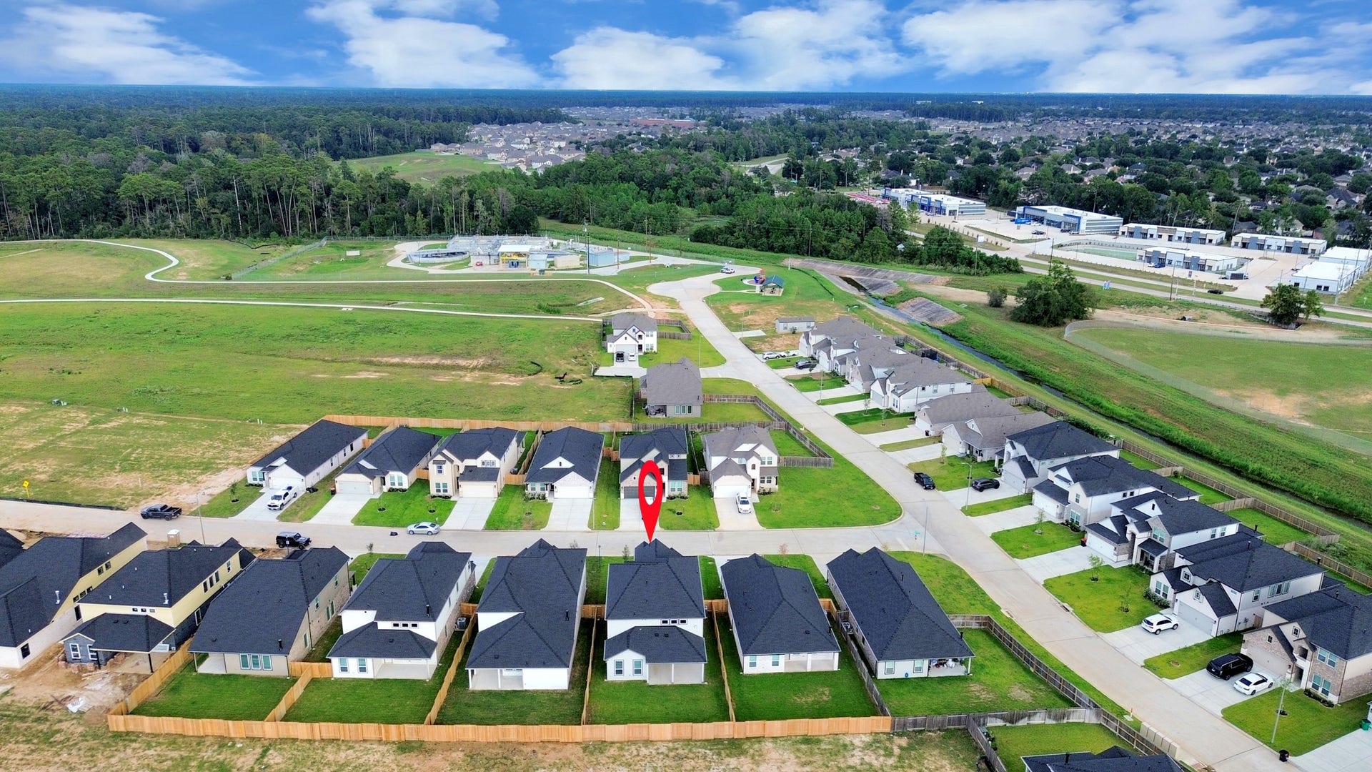 24511 Broad Park Ct, Spring, TX 77373 An aerial view of a spacious subdivision lot, highlighting a well-maintained yard and a fully fenced perimeter, offering both privacy and expansive outdoor space.