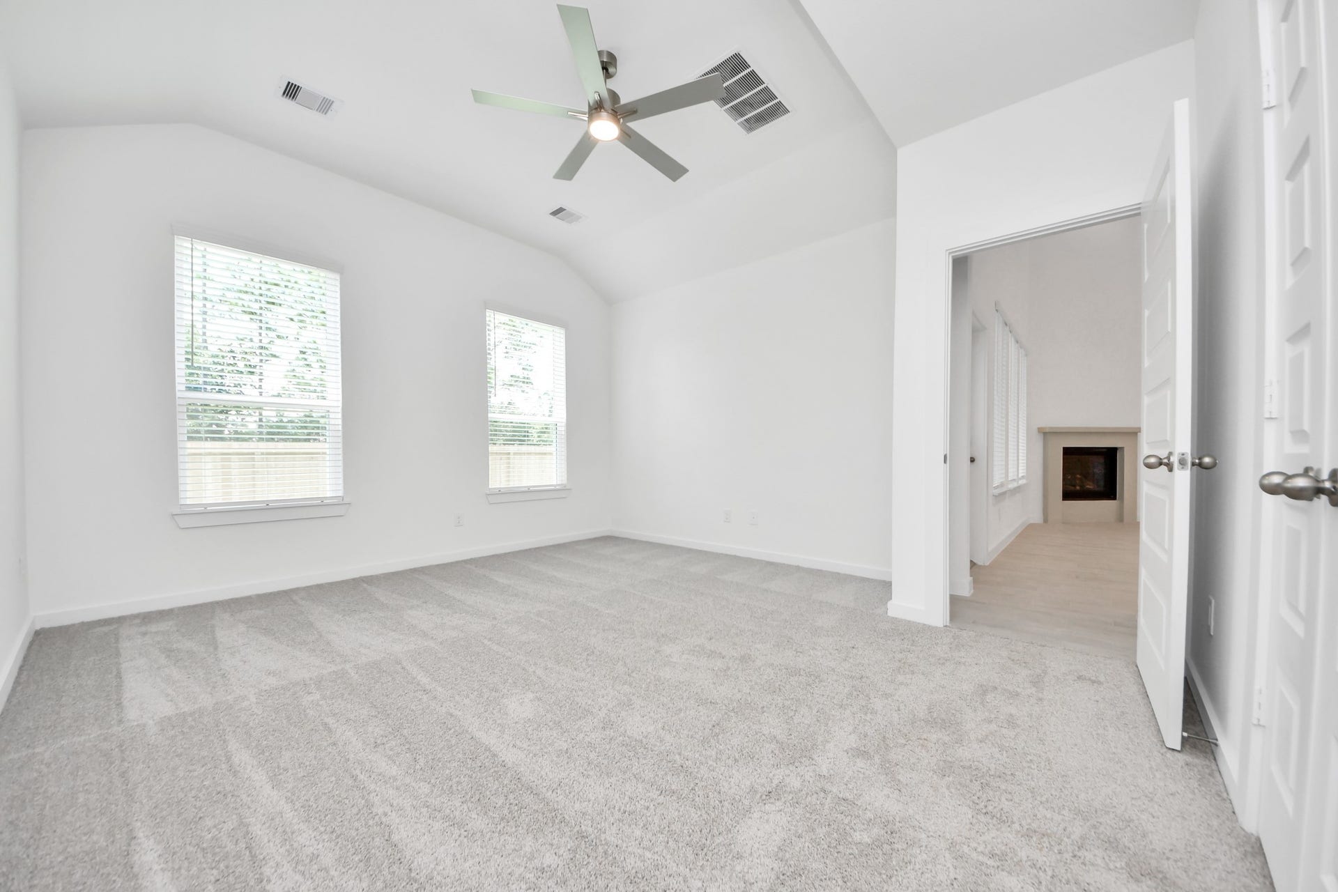 24511 Broad Park Ct, Spring, TX 77373 Come and unwind after a long day in this magnificent primary suite! This spacious room features plush carpet, warm paint, high ceilings and large windows with privacy blinds. Sample photo of completed home with similar floor plan. Actual colors and selections may vary.