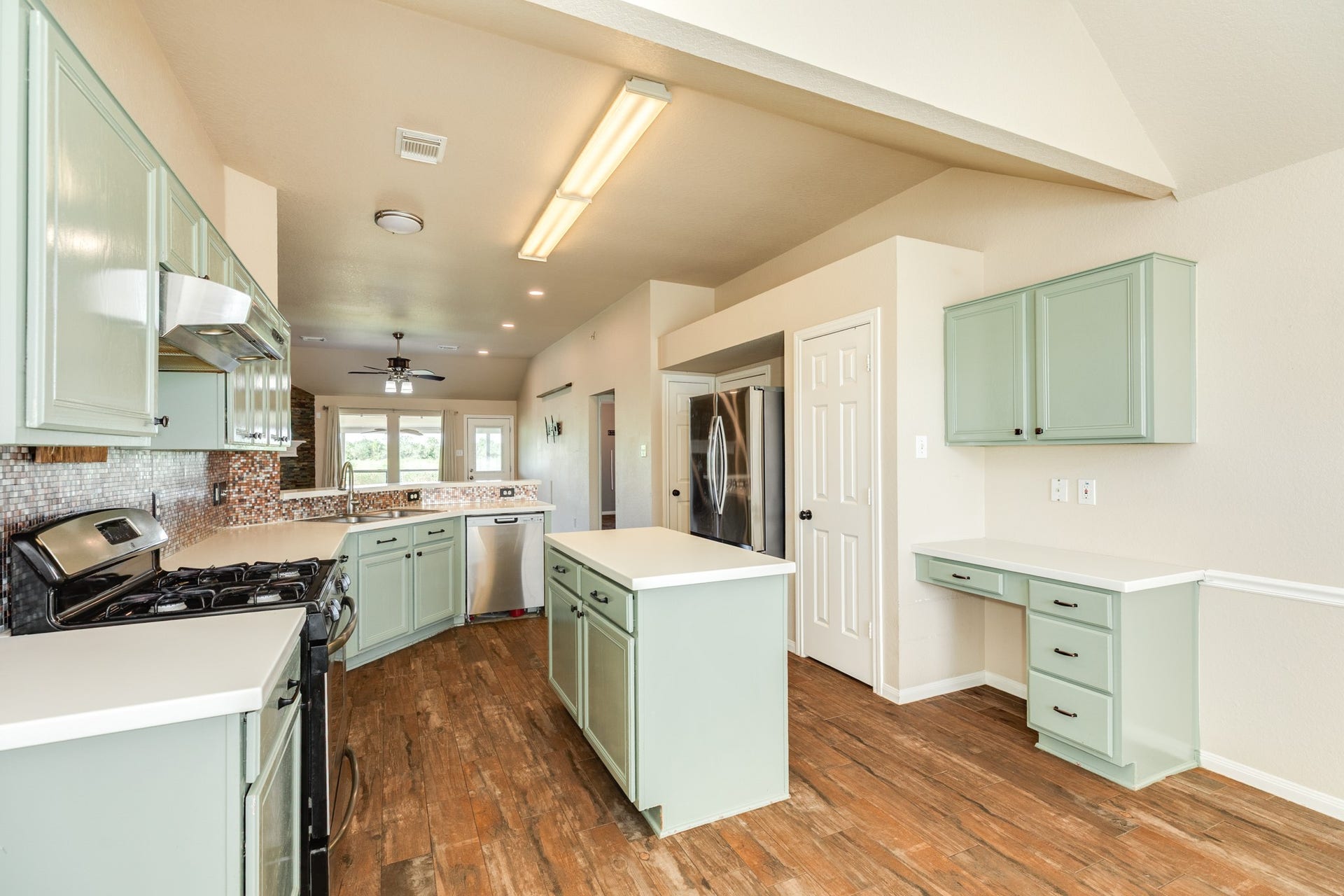 3425 Van Ness Drive, Alvin, TX 77511 Kitchen features ample cabinetry plus built in workstation/desk area