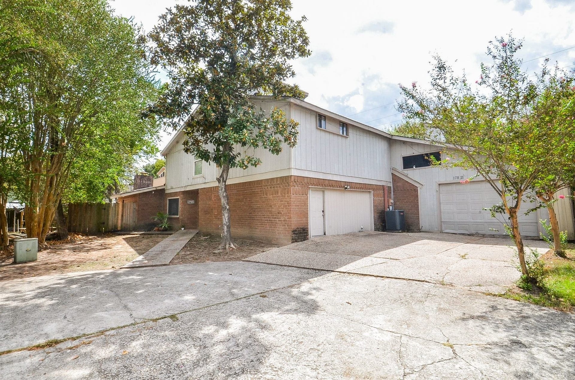 17821 S Cypress Villas Drive, Spring, TX 77379 Ample parking with an extra-long driveway and multiple garage bays. Note: the left-side two-car bay is currently enclosedno overhead doorand finished with drywall, with a single service door providing interior access.