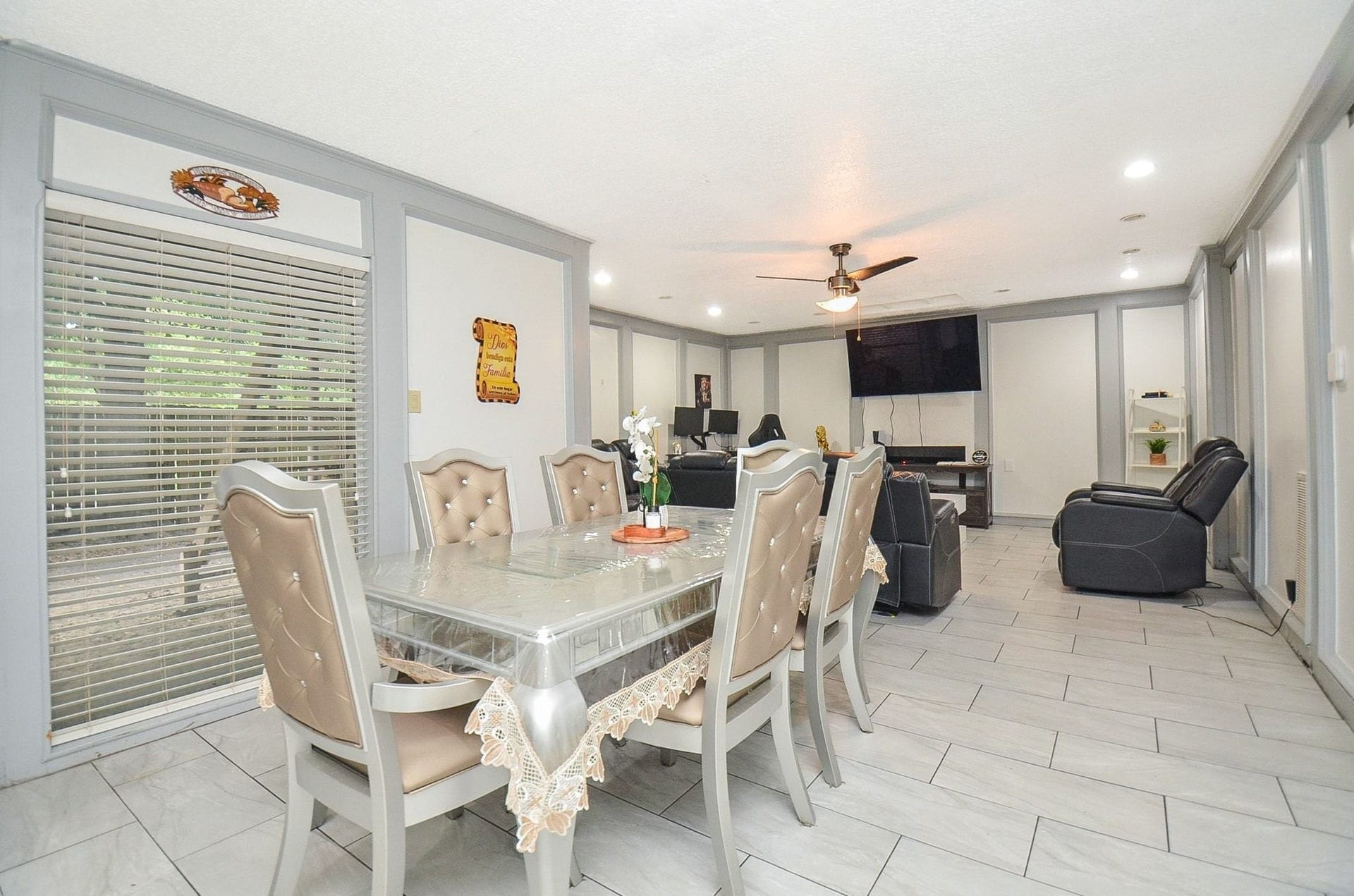 17821 S Cypress Villas Drive, Spring, TX 77379 Step into this spacious open-concept dining and living area with modern tile flooring, recessed lighting, and accent wall molding detail!