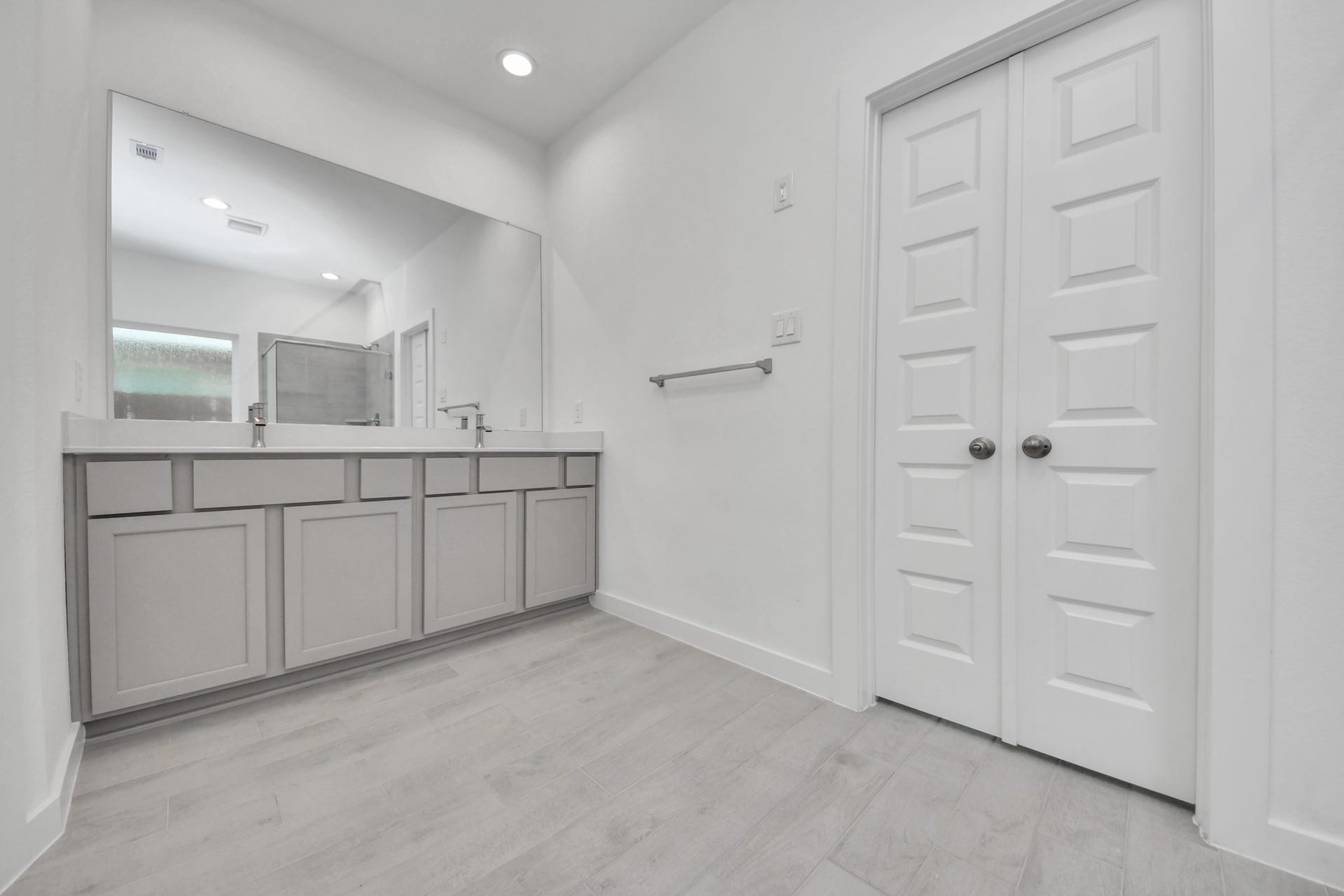 2203 Demeter Place, Fresno, TX 77545 Elevate your daily routine at the elegant vanity, now equipped with double sinks, light countertops, modern hardware, and beautiful recessed lights. Sample photo of completed home with similar floor plan. Actual colors and selections may vary.