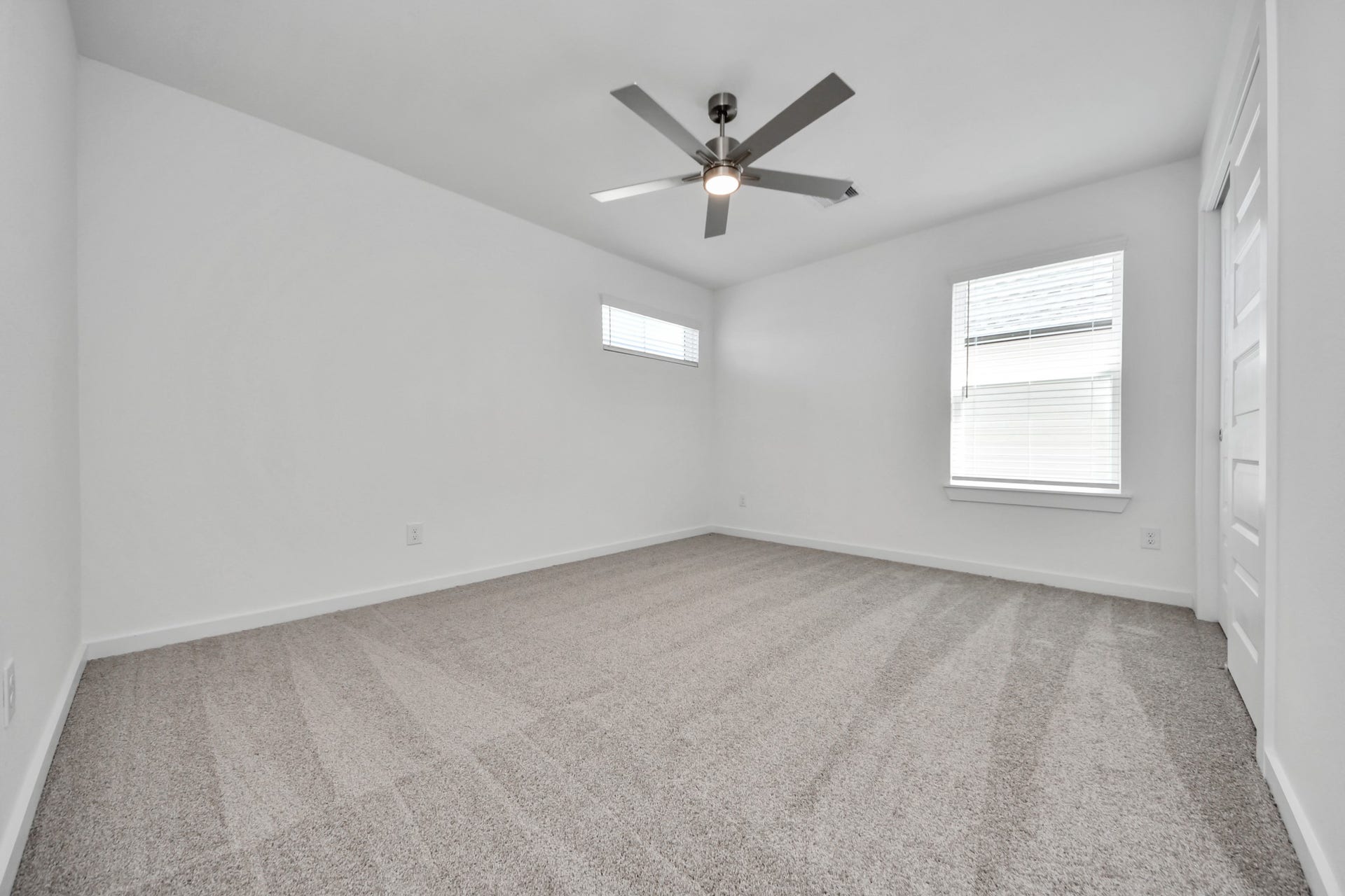 2203 Demeter Place, Fresno, TX 77545 Secondary bedroom features plush carpeting, large windows that let in plenty of natural light, bright paint, and spacious closets. Sample photo of completed home with similar floor plan. Actual colors and selections may vary.