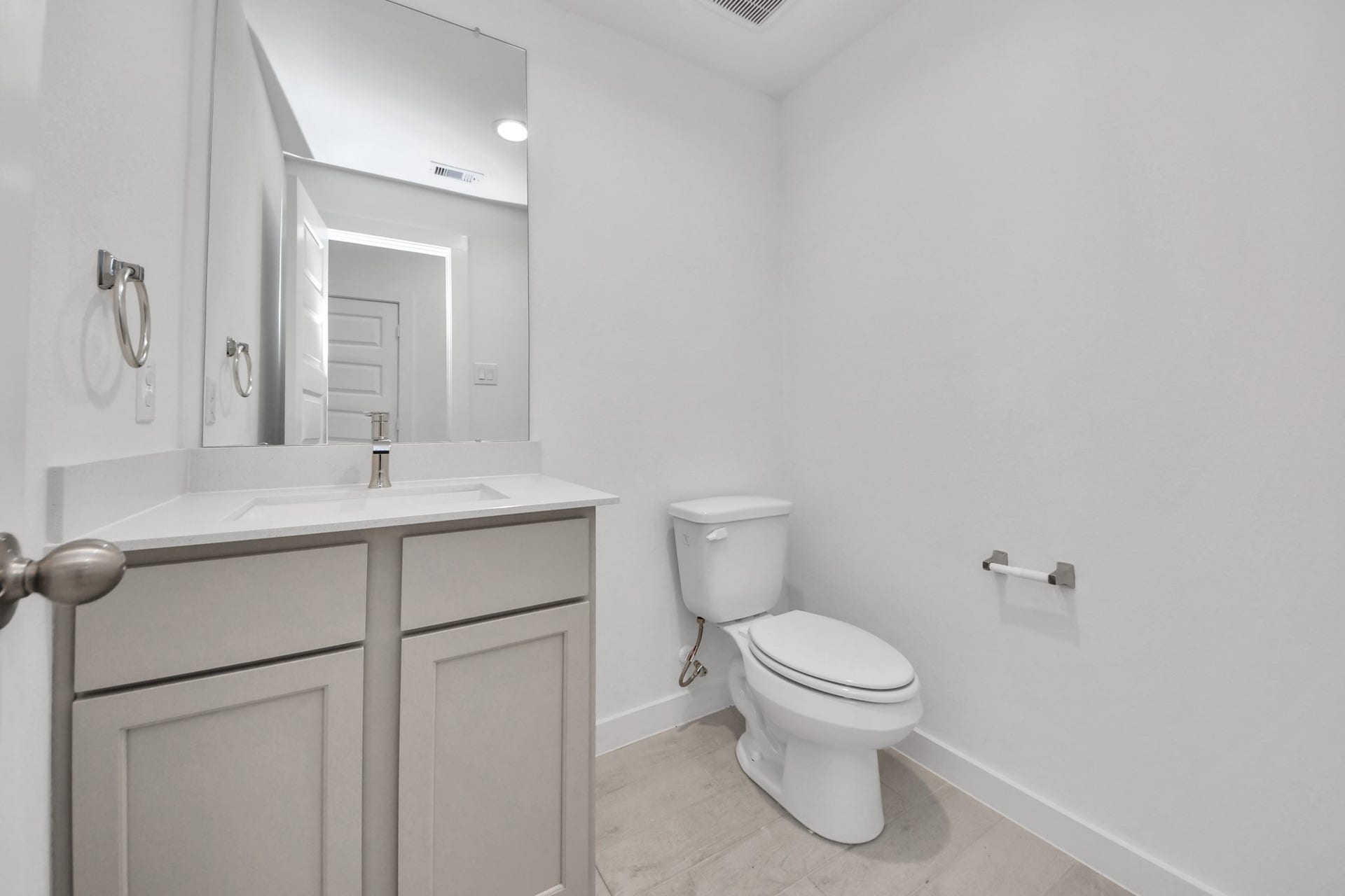 2203 Demeter Place, Fresno, TX 77545 Sophisticated half bathroom adorned with contemporary finishes. The elegant 5-panel door welcomes you to a space where style meets functionality. Notice the sleek hardware accents that add a touch of modern charm. The vanity boasts light-colored countertops, beautifully complemented by a tasteful vanity light, creating a well-lit and inviting atmosphere. Sample photo of completed home with similar floor plan. Actual colors and selections may vary.