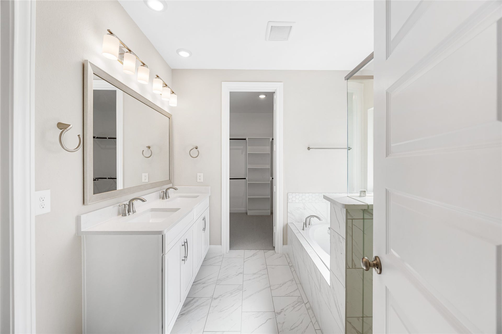 The primary bathroom features dual sinks.