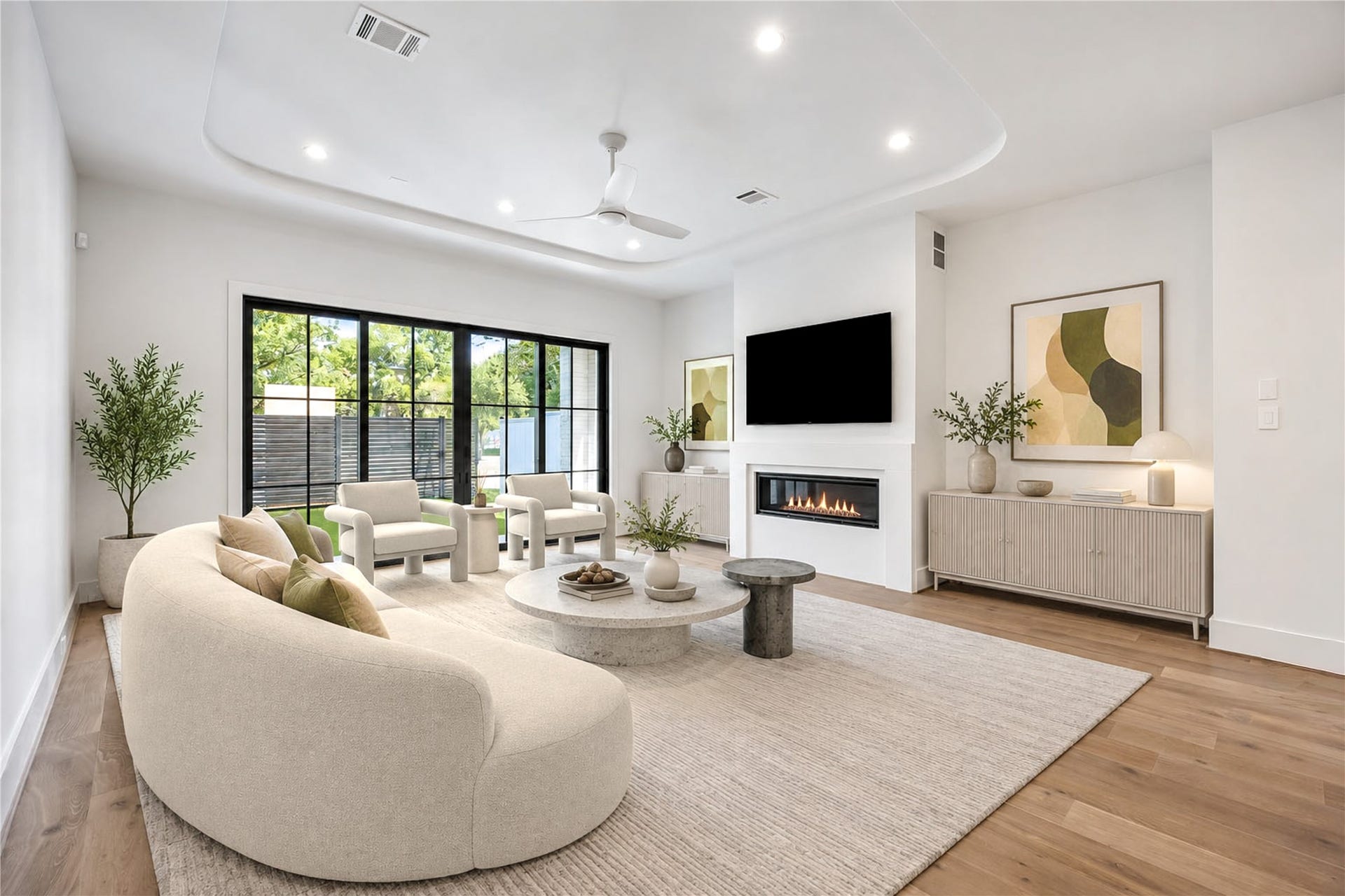 6303 Rodrigo Street, #A, Houston, TX 77007 Living room offers a sleek fireplace, ceiling fan and sliding glass doors overlooking the backyard. (Virtual staging)