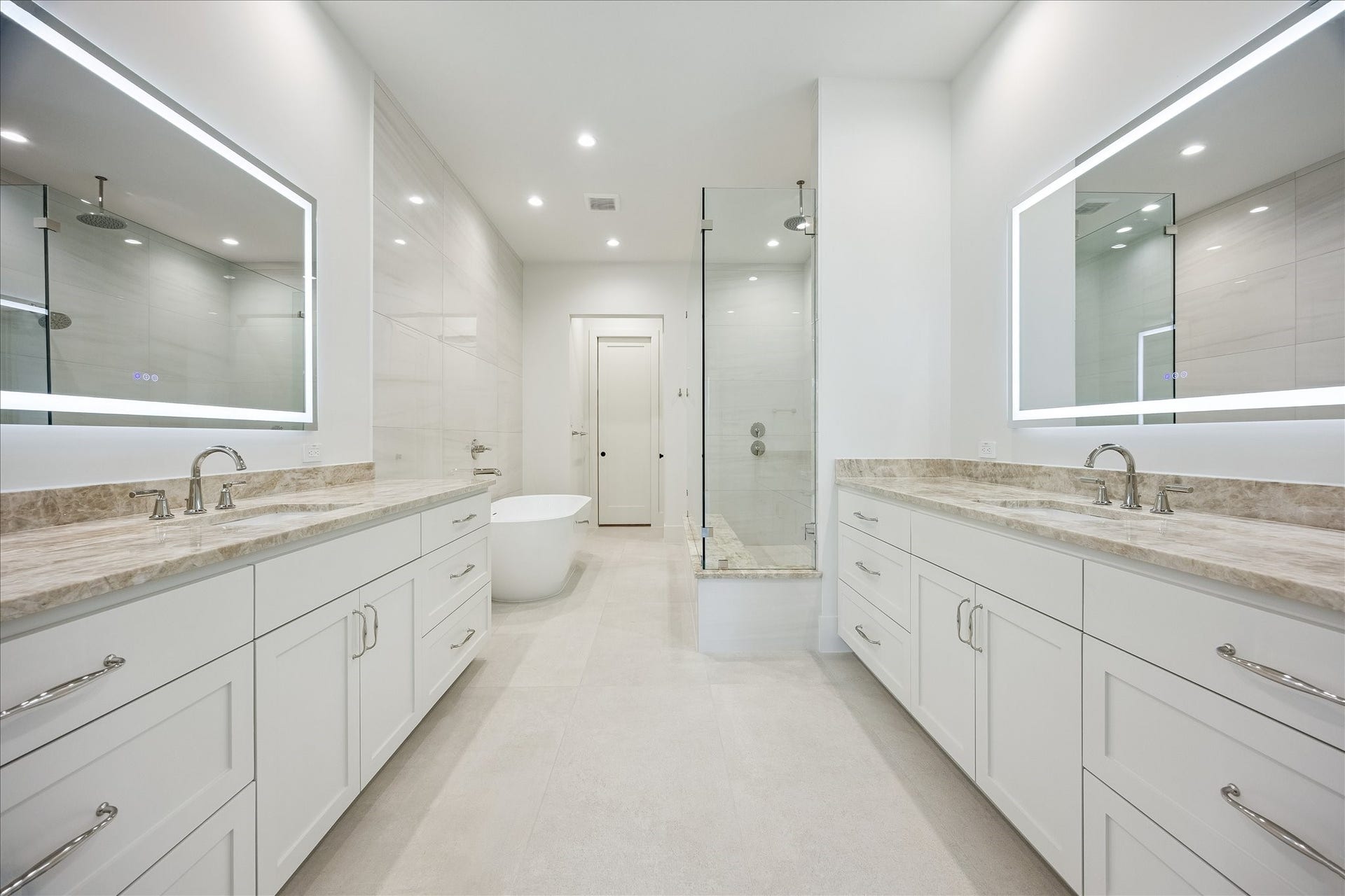 6303 Rodrigo Street, #A, Houston, TX 77007 Spa like primary bath features dual vanities, illuminated mirrors, a freestanding tub and spacious walk-in shower.