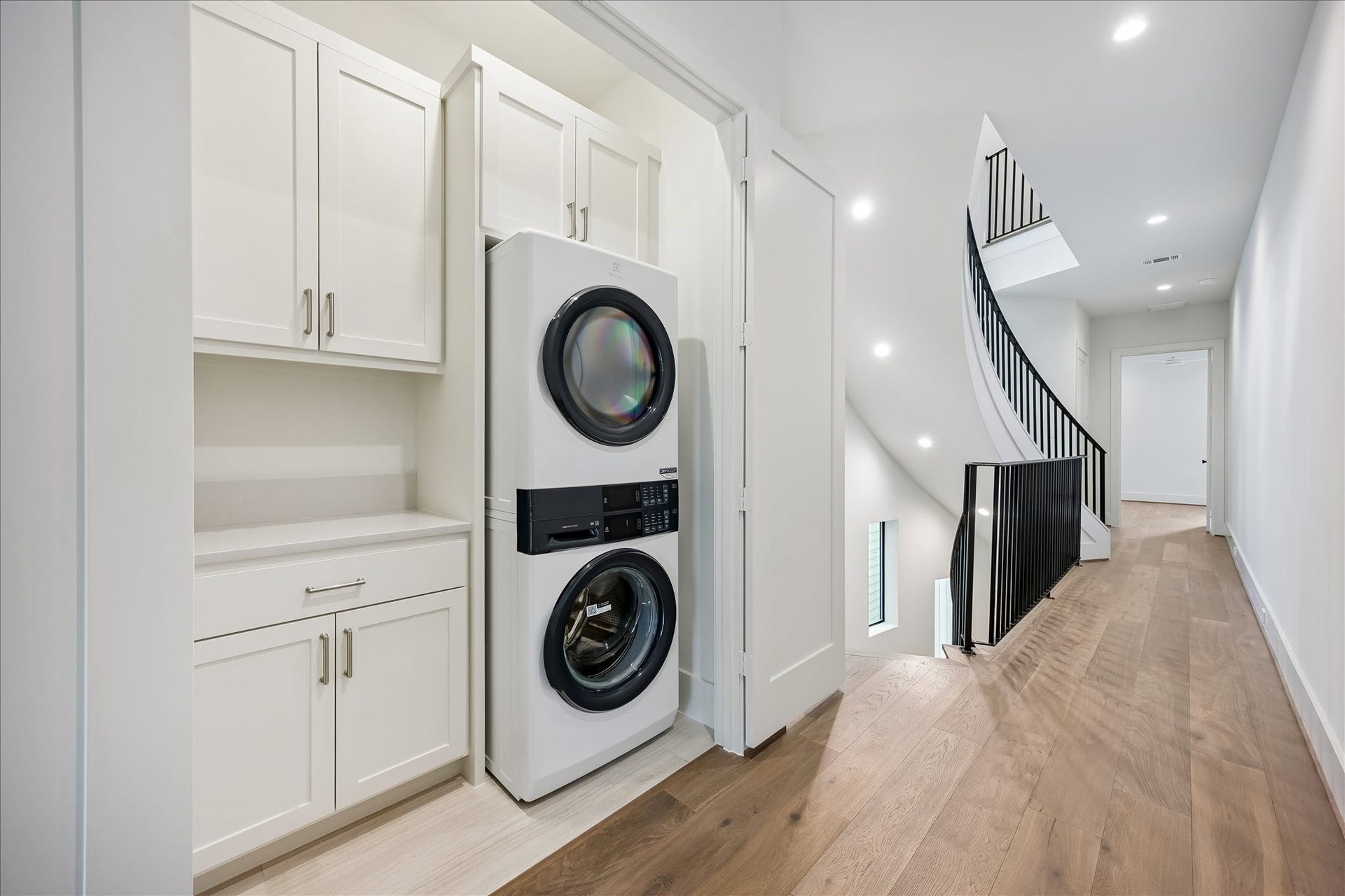 6303 Rodrigo Street, #A, Houston, TX 77007 Utility room features built-in cabinetry, countertop space and room for full-size stacked washer and dryer.