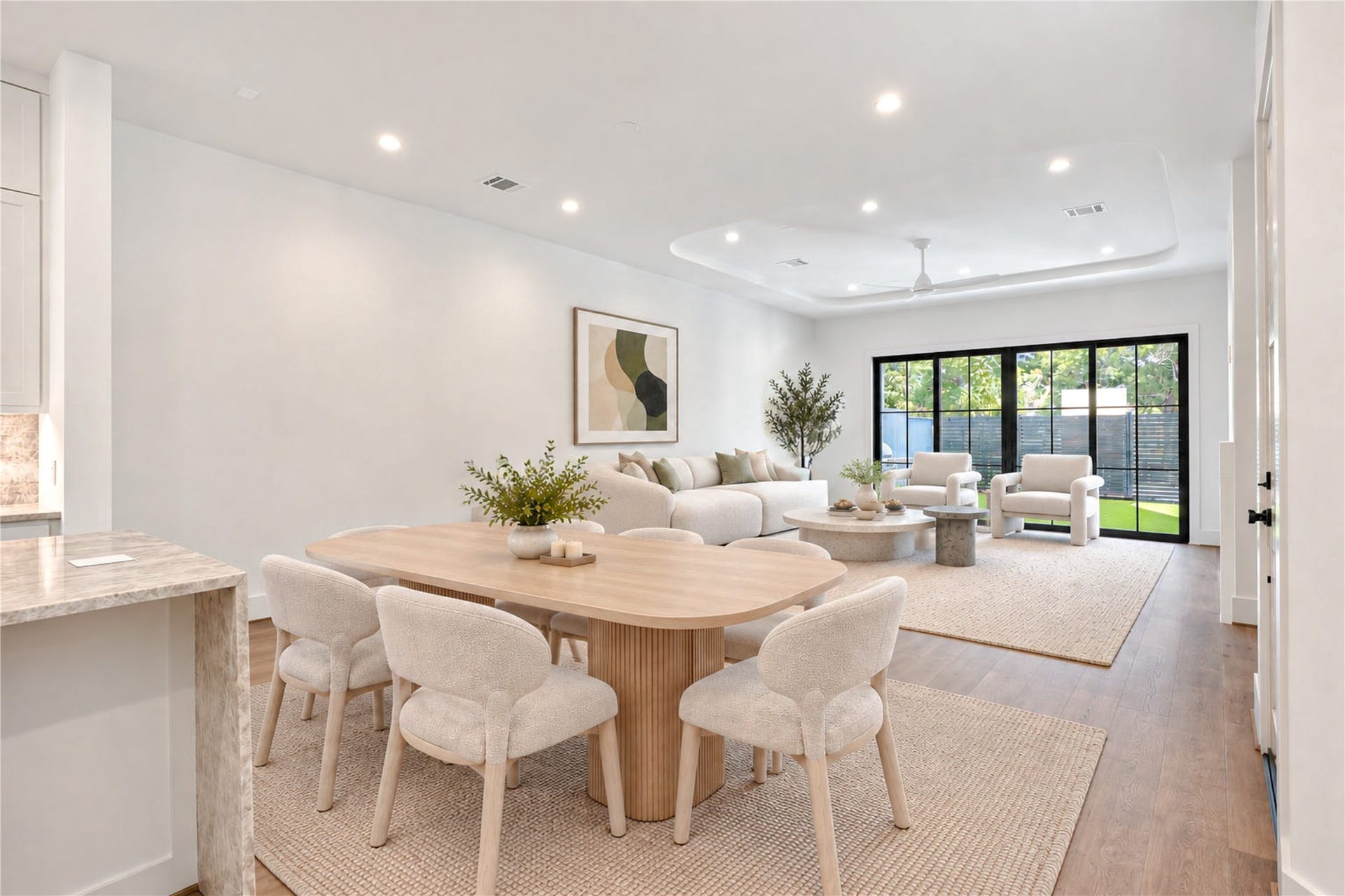 6303 Rodrigo Street, #A, Houston, TX 77007 Open living and dining area features wood flooring, recessed lighting and views of the backyard. (virtual staging)