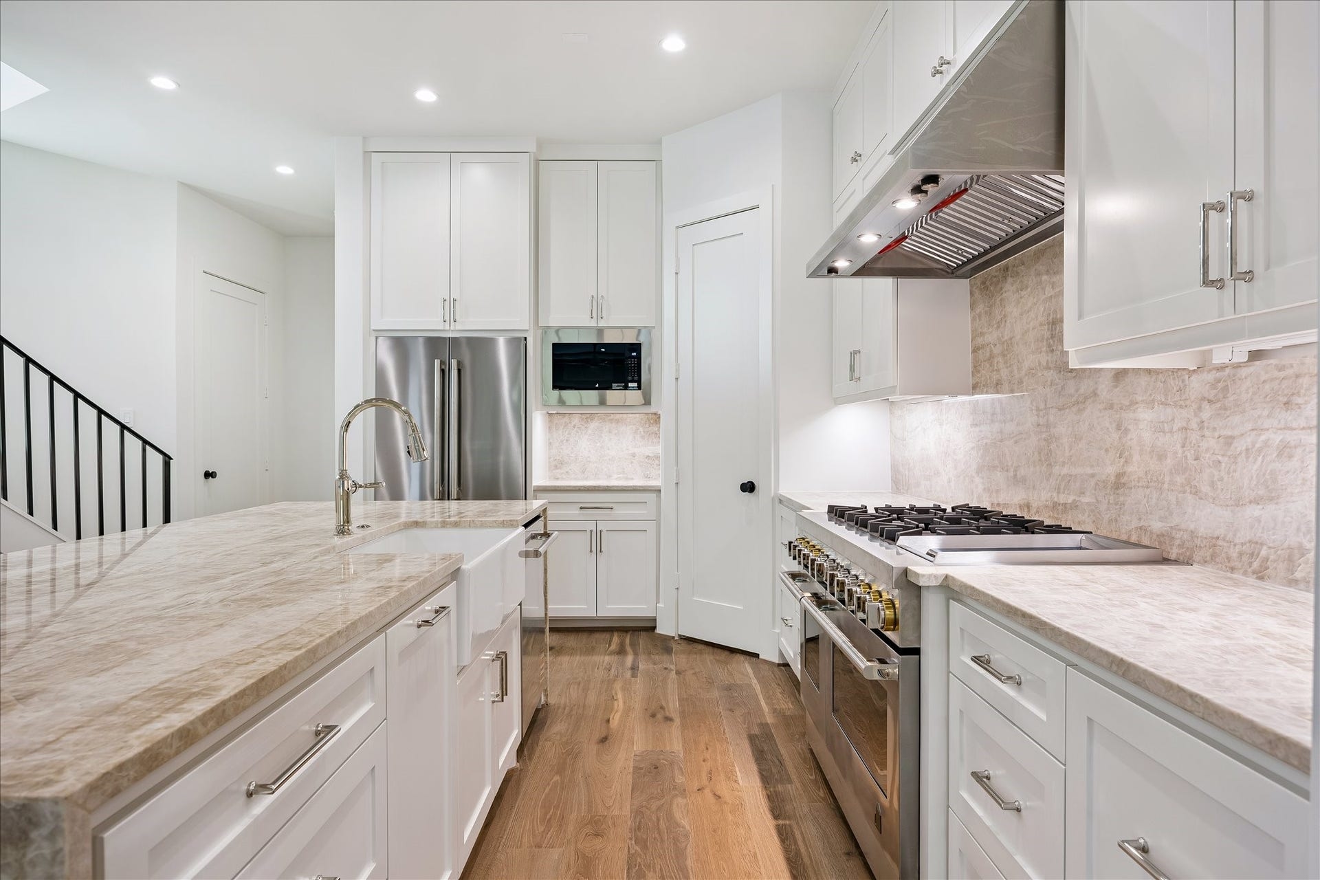 6303 Rodrigo Street, #A, Houston, TX 77007 Kitchen offers ample cabinetry, quartz countertops and matched backsplash and stainless steel Jennair appliances.