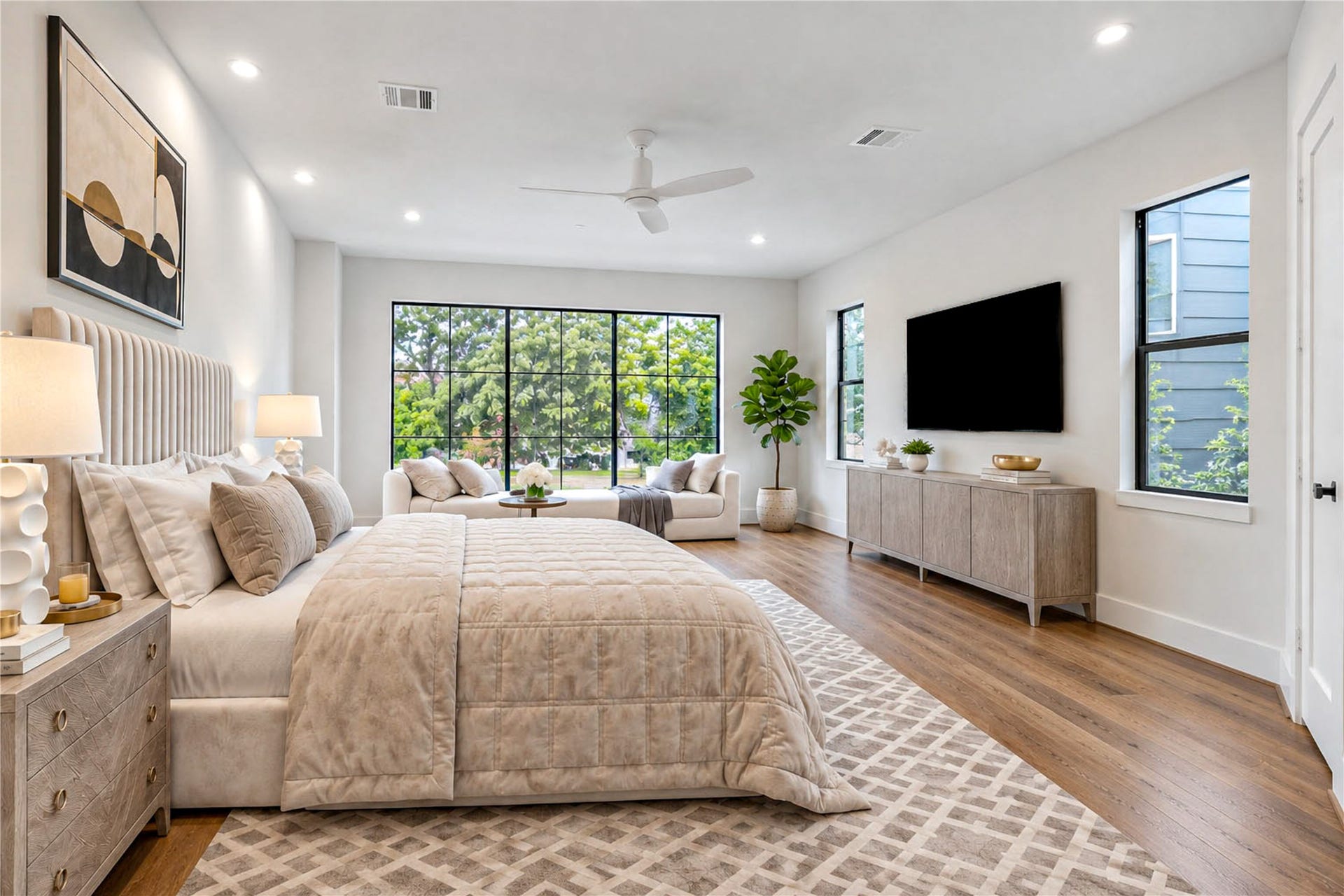 6303 Rodrigo Street, #A, Houston, TX 77007 Primary suite spacious retreat featuring wood flooring, recessed lighting and large windows. (virtual staging)