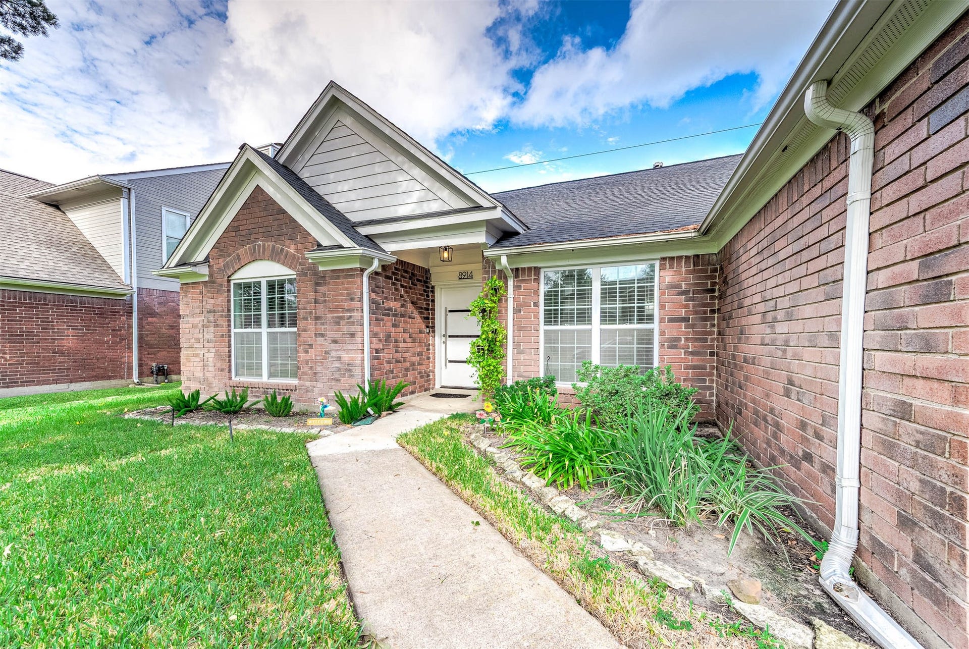8914 Sunny Point Drive, Spring, TX 77379 Approaching the front door you will
see the beautiful brick elevation,
covered front porch, and lovely
landscaping!