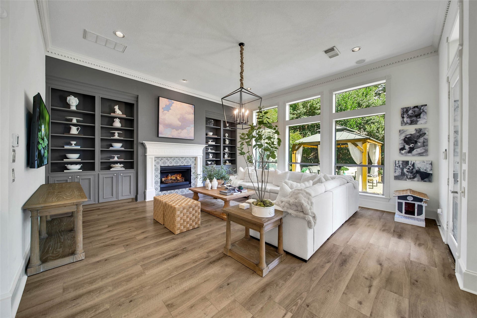 39 W Old Sterling Circle, The Woodlands, TX 77382 Spacious family room with a warm fireplace, elegant built-in shelves, and abundant natural light.