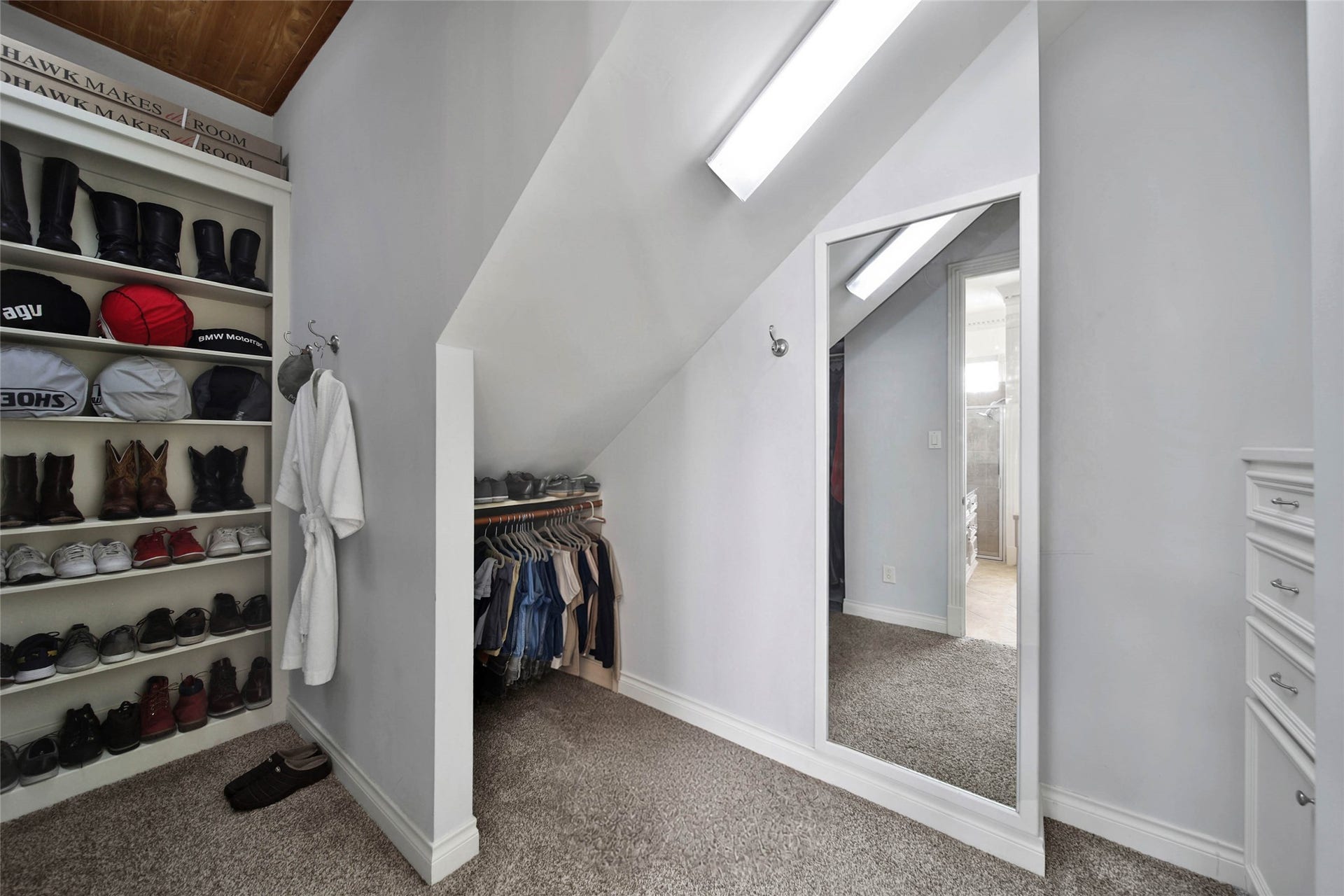 39 W Old Sterling Circle, The Woodlands, TX 77382 His closet features custom built-ins, offering organized and stylish storage for shoes and accessories.
