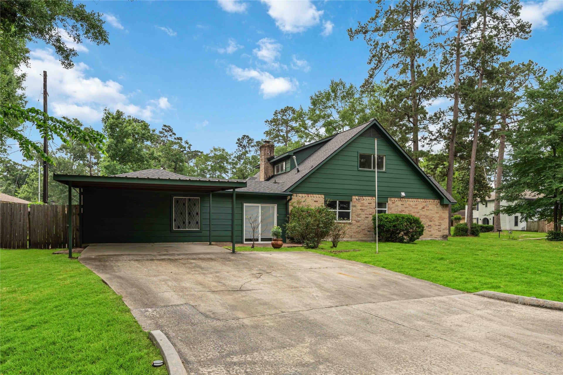 203 Wedgewood Court, Oak Ridge North, TX 77386 Carport in side driveway