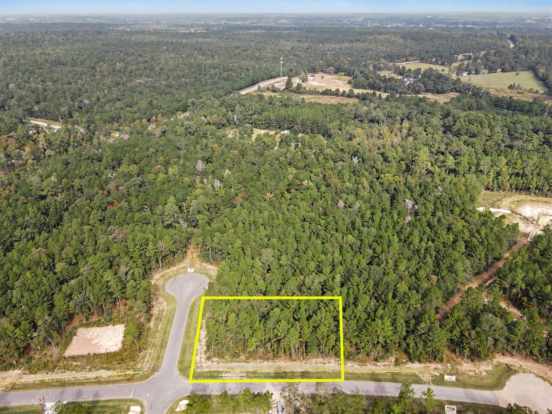 Here you can see the acreage community is fully treed and a cul-de-sac north and to the right.