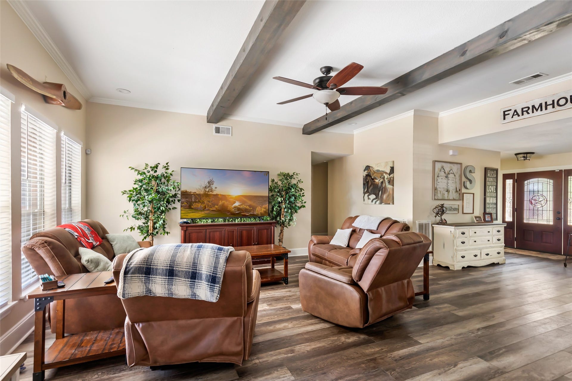 25107 Goodson Road, Splendora, TX 77372 Charming living area with rustic beams, cozy recliners, and abundant natural light, offering a welcoming, farmhouse-inspired atmosphere.