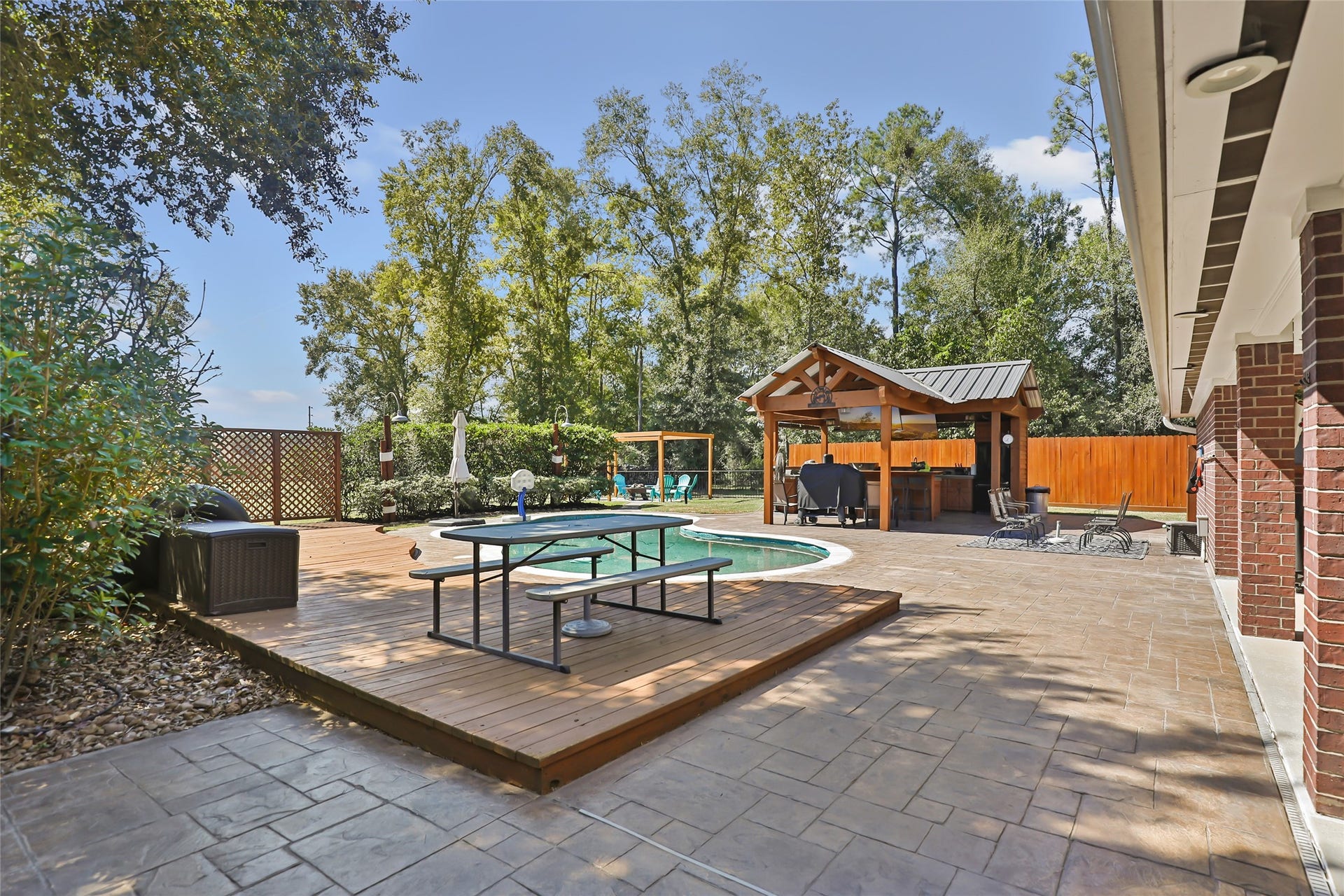 25107 Goodson Road, Splendora, TX 77372 Experience outdoor luxury with a beautifully designed pool, a spacious deck for lounging, and a charming gazebo perfect for entertaining.