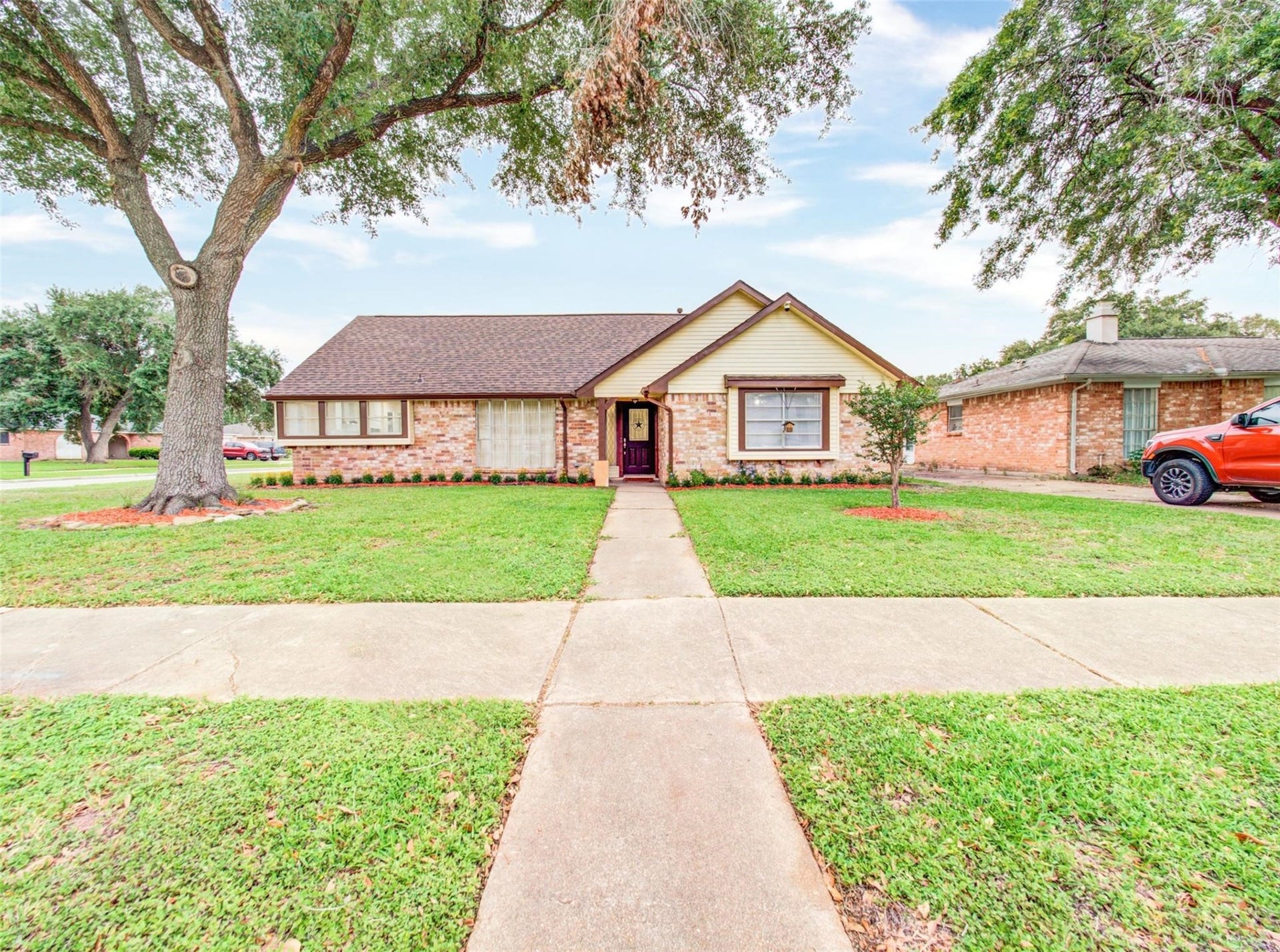 13526 Sherwood Street, Sugar Land, TX 77498 Charming single-story brick home with a well manicured front yard, mature trees, and Corner Lot.