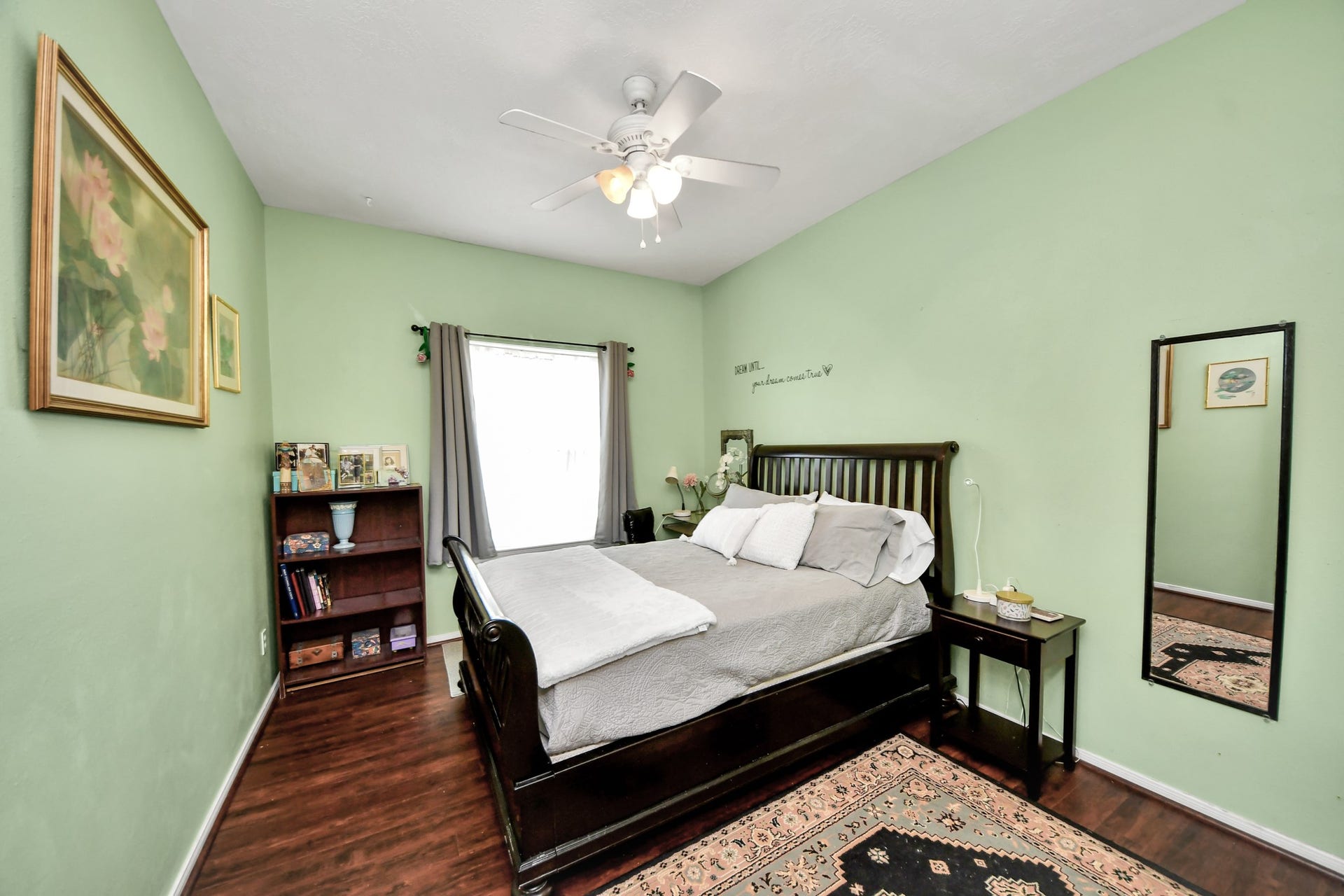 Another well-sized secondary bedroom with a ceiling fan and plenty of room for furniture.