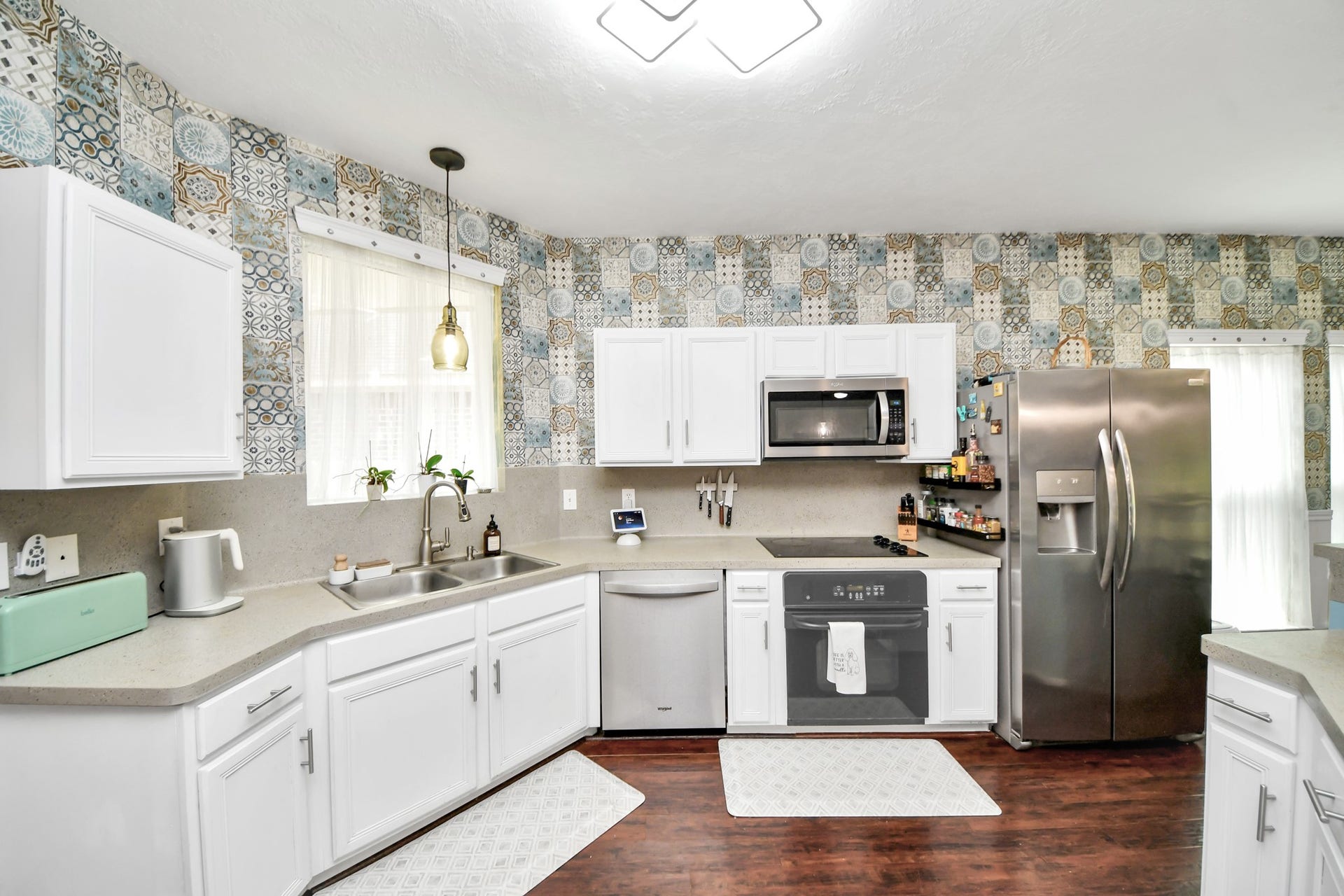 Bright kitchen with white cabinets, stainless-steel appliances, and plenty of counter space.