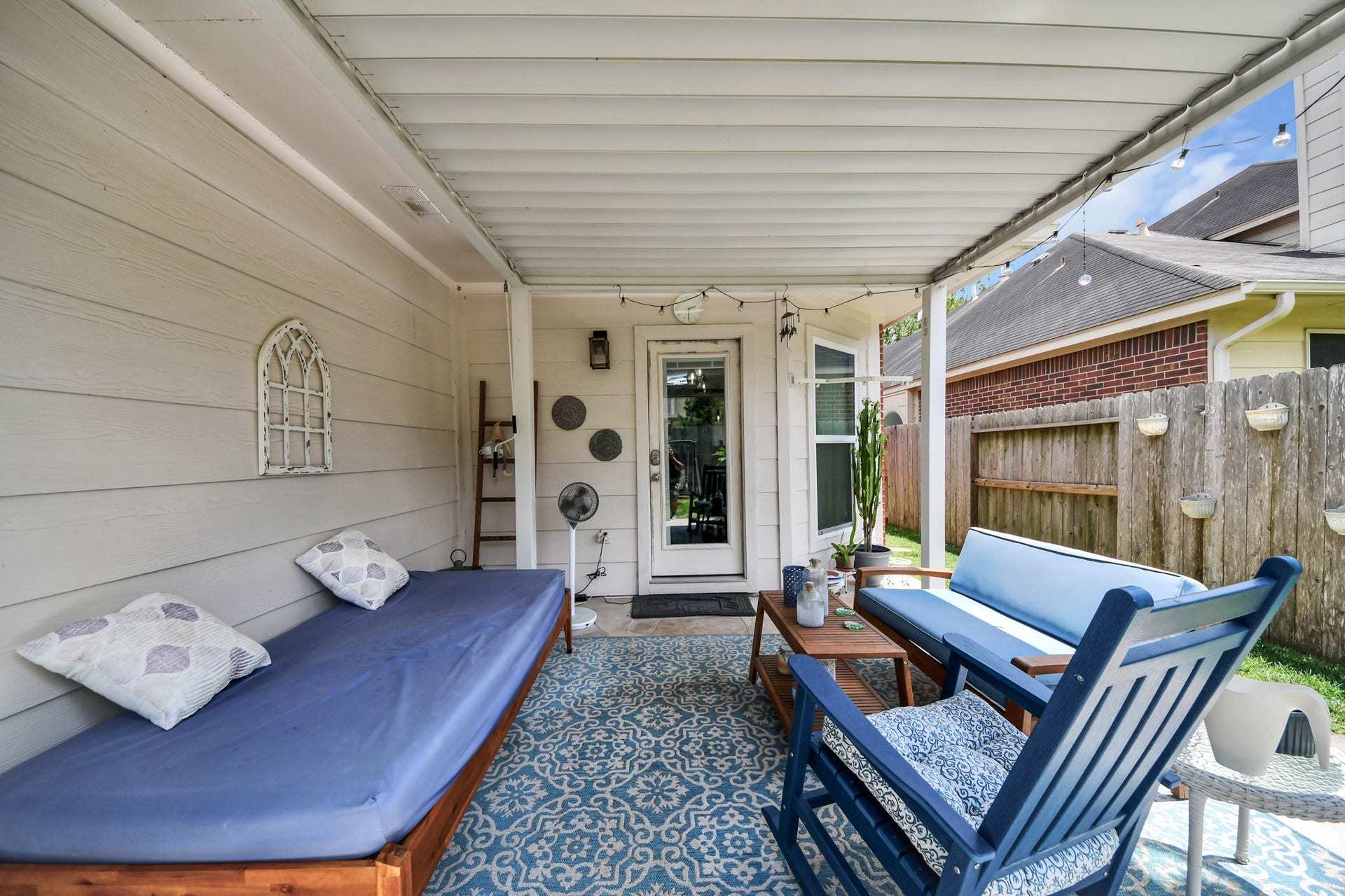A comfortable outdoor gathering area with room for lounging, dining, and entertaining.