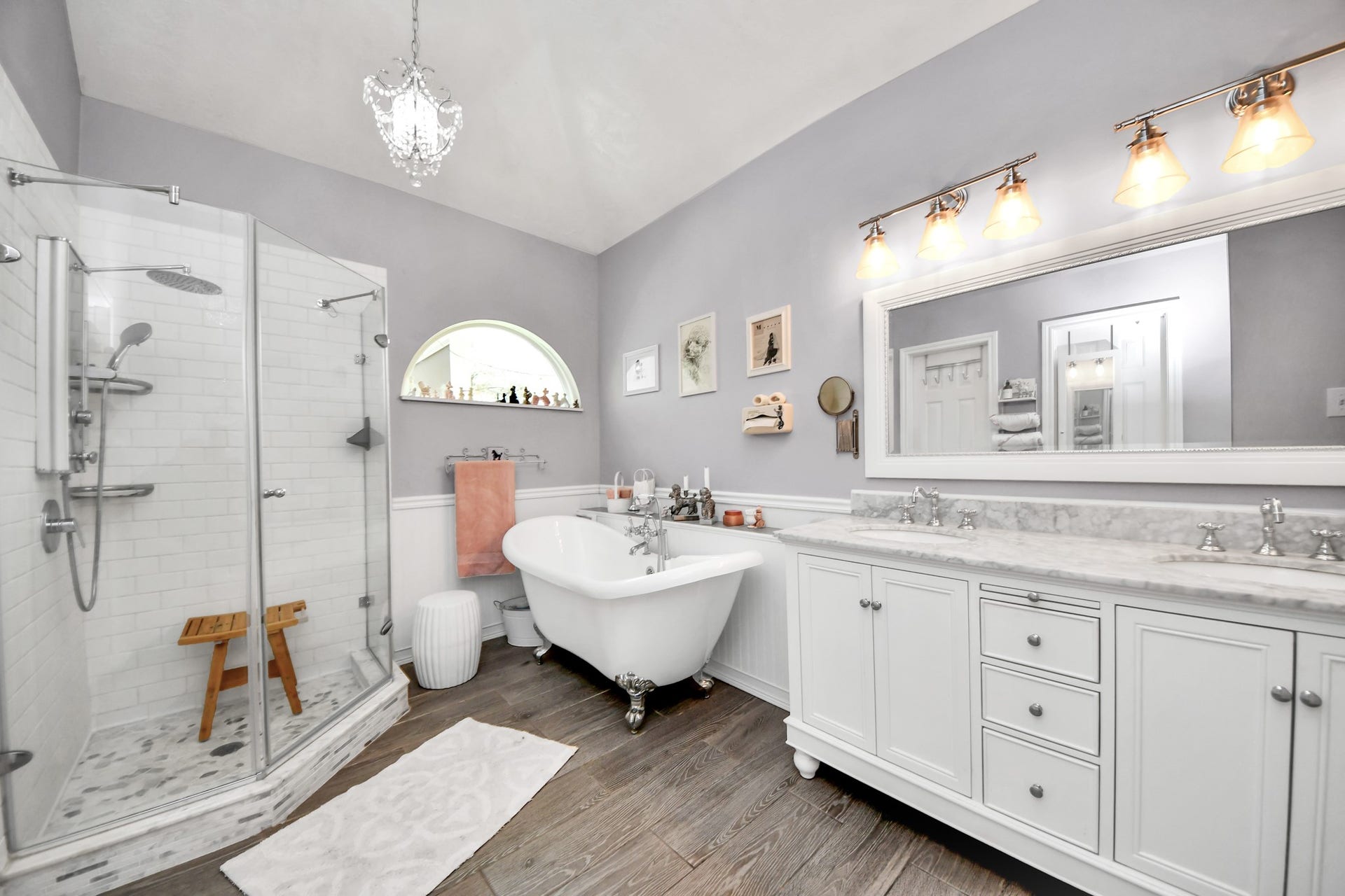 The primary bathroom features a freestanding tub, separate shower, and long double vanity.