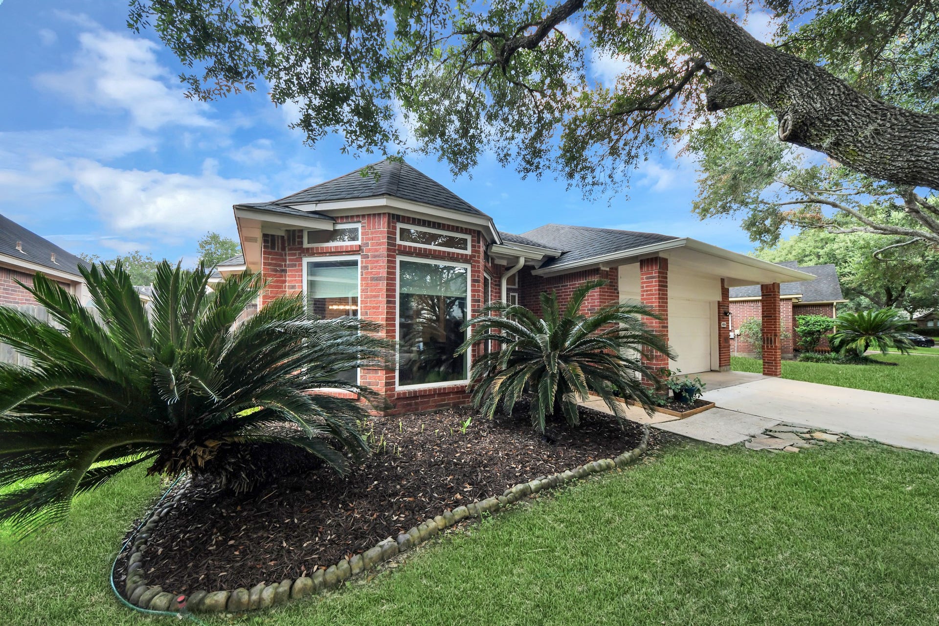 Brick exterior, established landscaping, and oversized front windows give this home plenty of character.