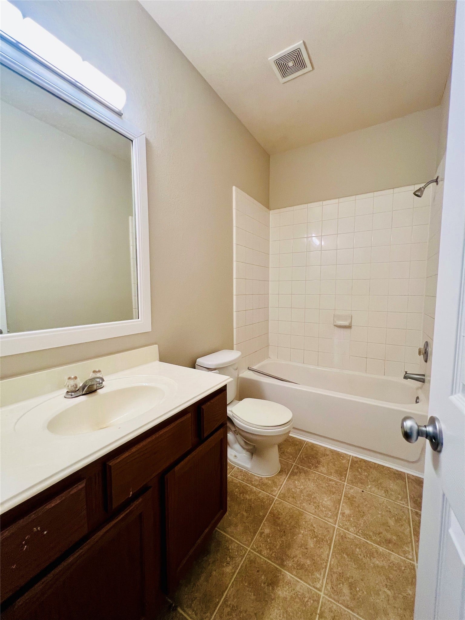 1721 Claremont Garden Circle, Houston, TX 77047 Bright and inviting bathroom featuring a classic white tile bathtub, elegant vanity, and neutral tones for a calming ambiance.
