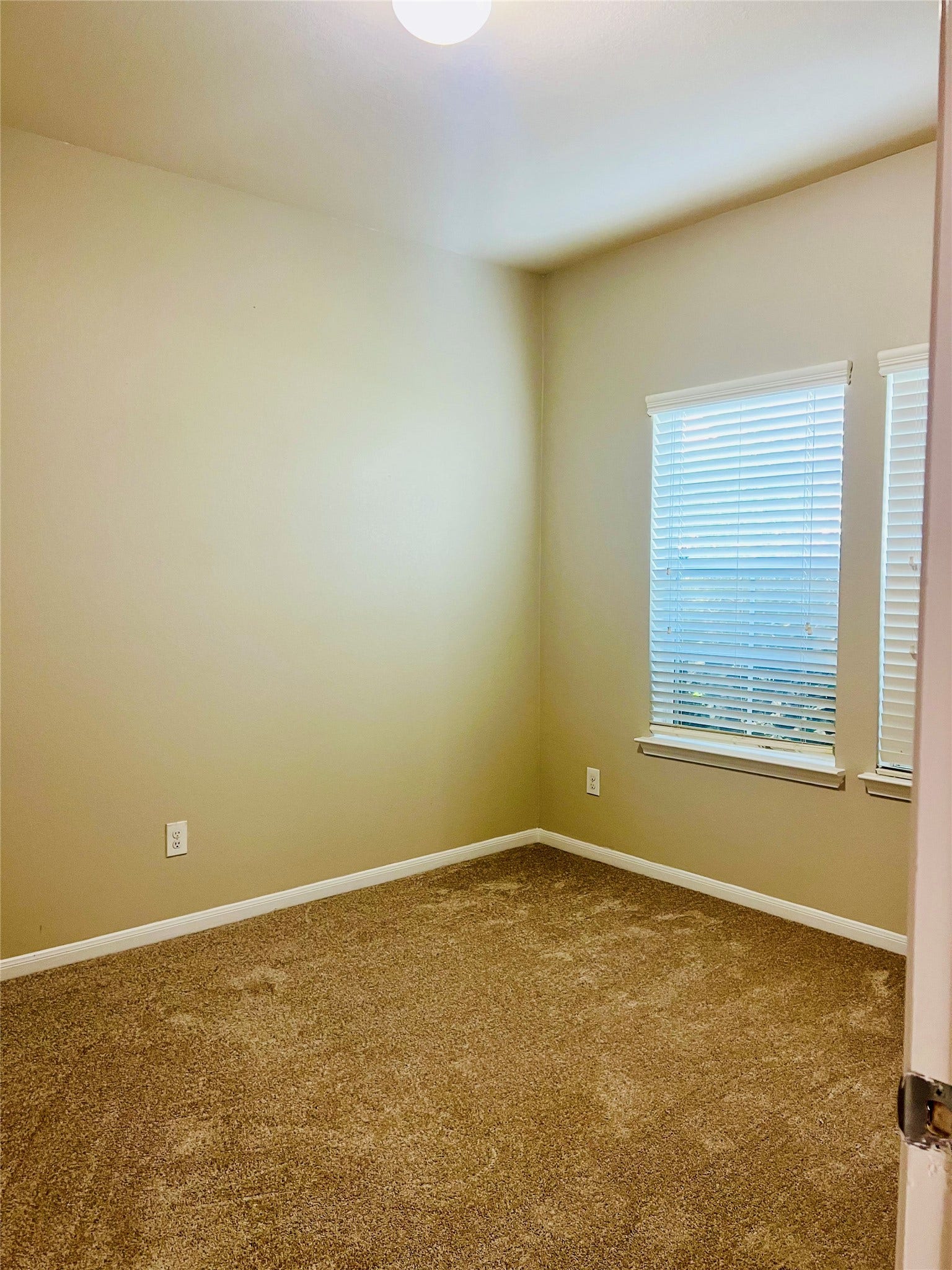 1721 Claremont Garden Circle, Houston, TX 77047 Cozy bedroom with soft carpet flooring, neutral walls, and a window that invites natural light.