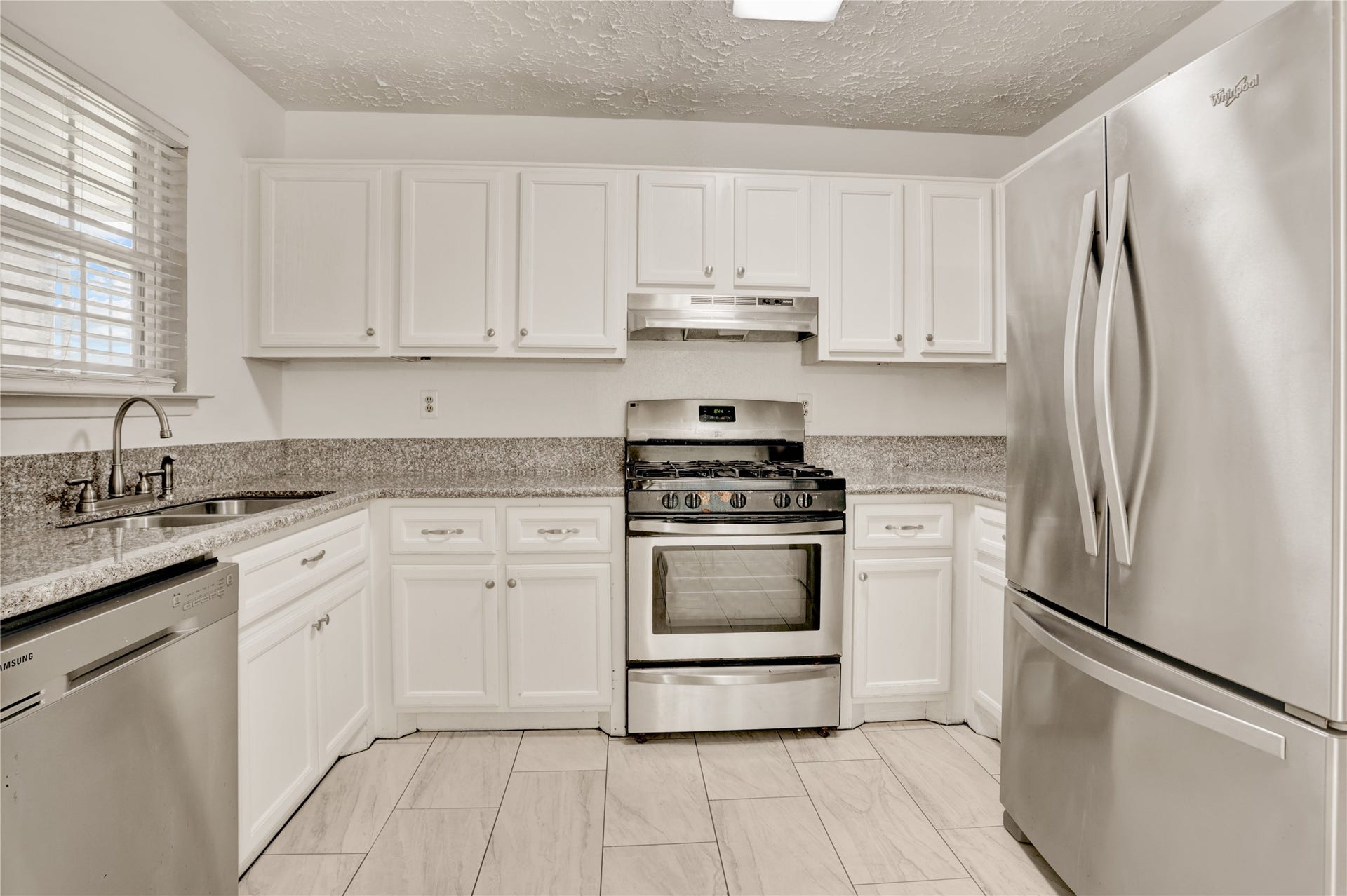 Updated kitchen featuring stainless steel appliances.