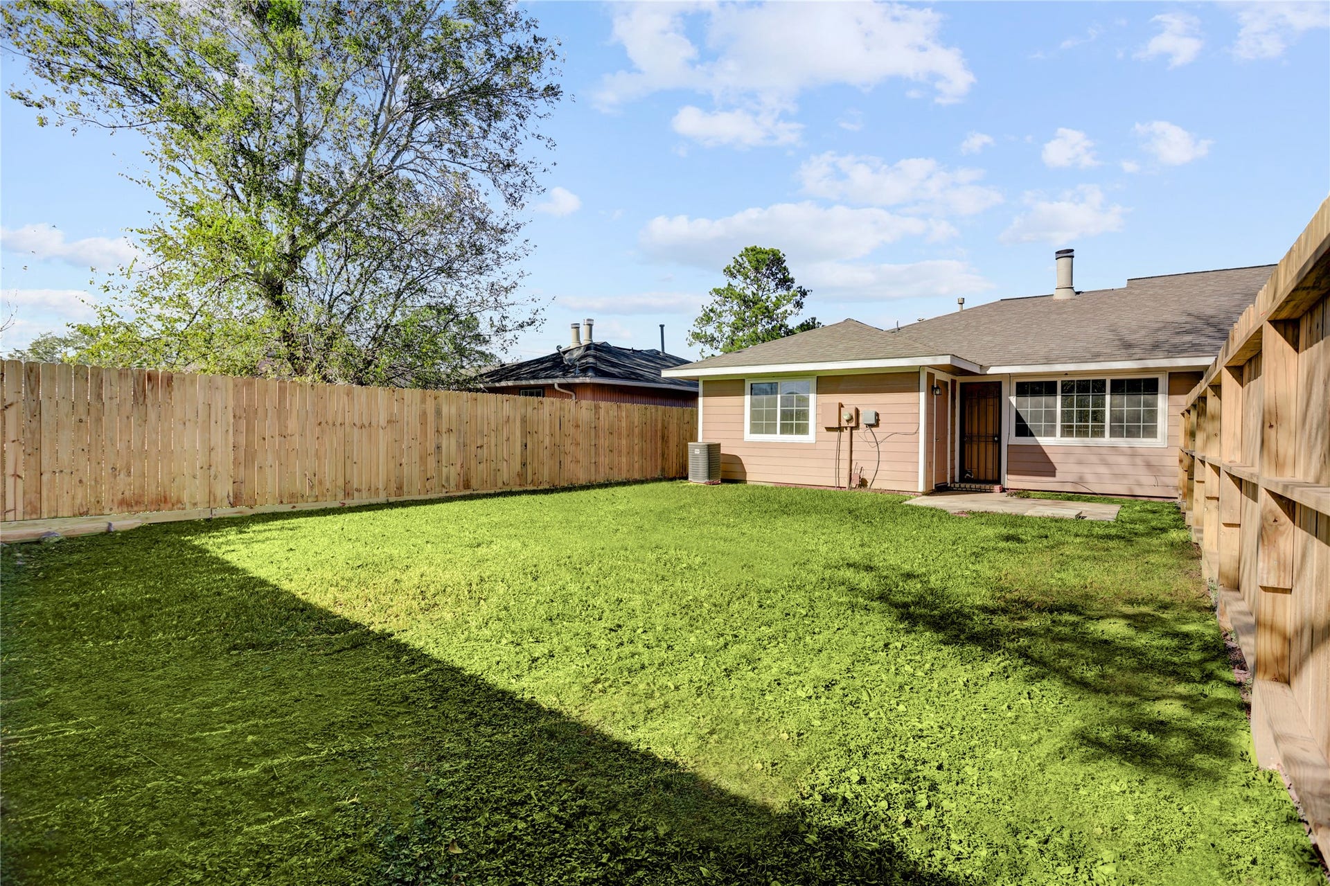 Generous backyard offering space for outdoor activities.