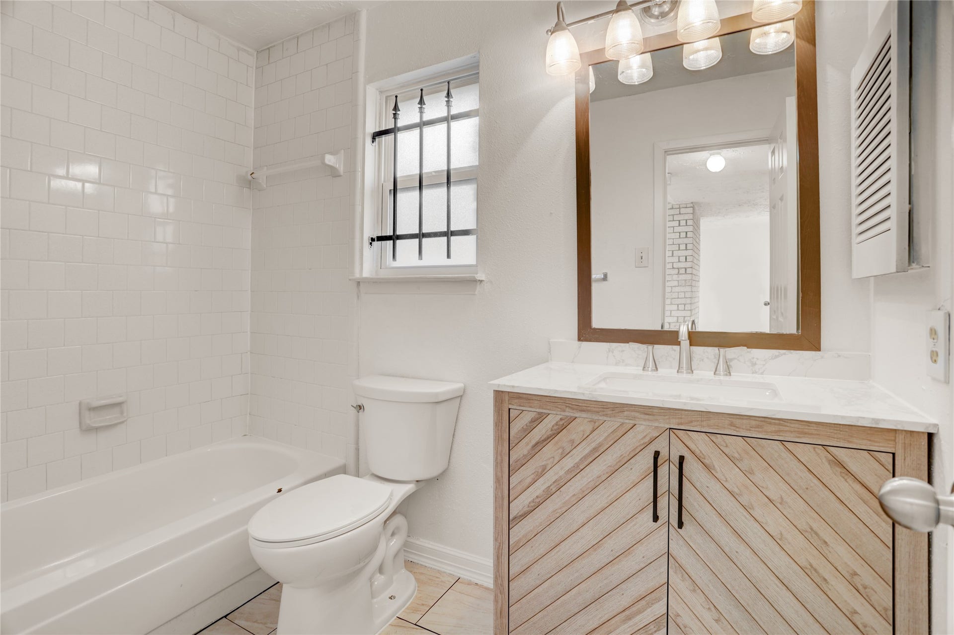 Convenient full bathroom with neutral finishes.