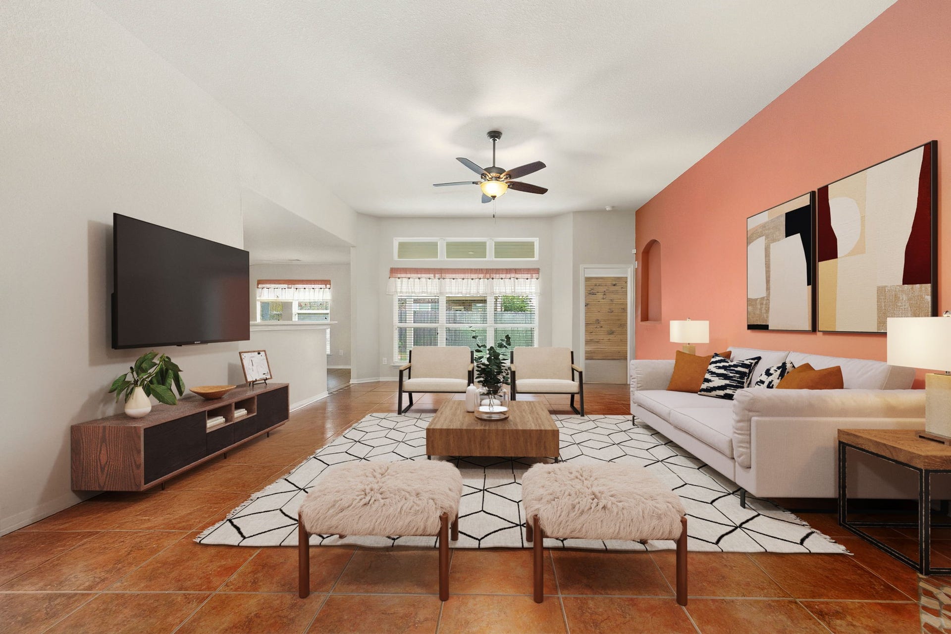 Spacious and inviting family room featuring high ceilings, durable tile flooring, and a central ceiling fan to ensure year-round comfort. Multiple large windows provide abundant natural light, while the expansive layout connects seamlessly to the rest of the home, creating an ideal layout for entertaining and daily living. *Virtually Staged