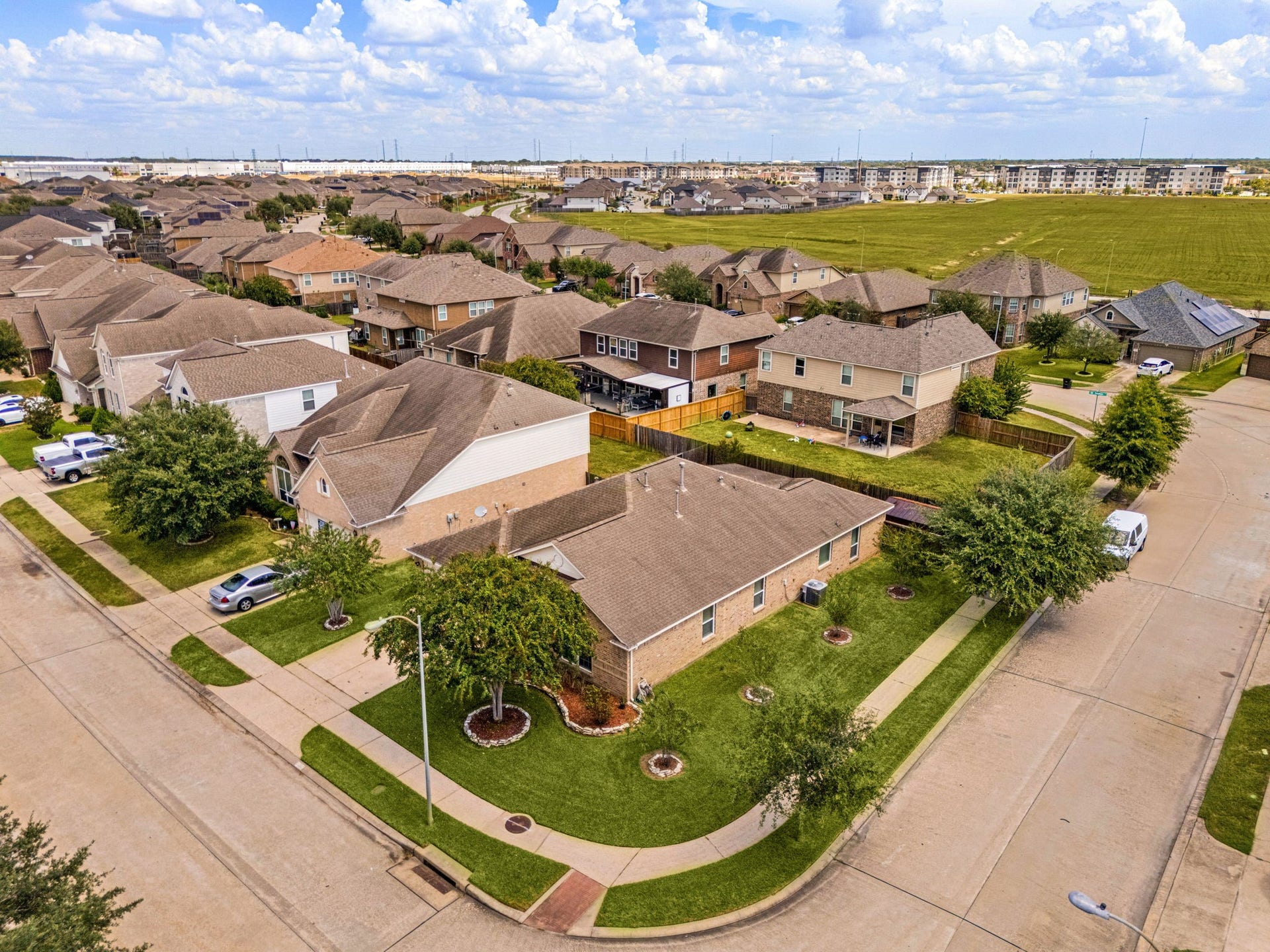 Stunning aerial perspective highlighting the prime location of 3102 Single Ridge Way on its expansive corner lot. This view showcases the property's generous boundaries and how beautifully the home sits within its spacious lot, offering a clear look at the surrounding neighborhood.